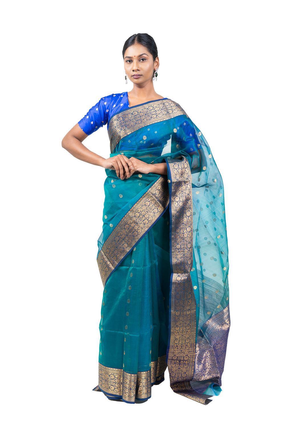 Woman wearing a blue and green saree with a white background