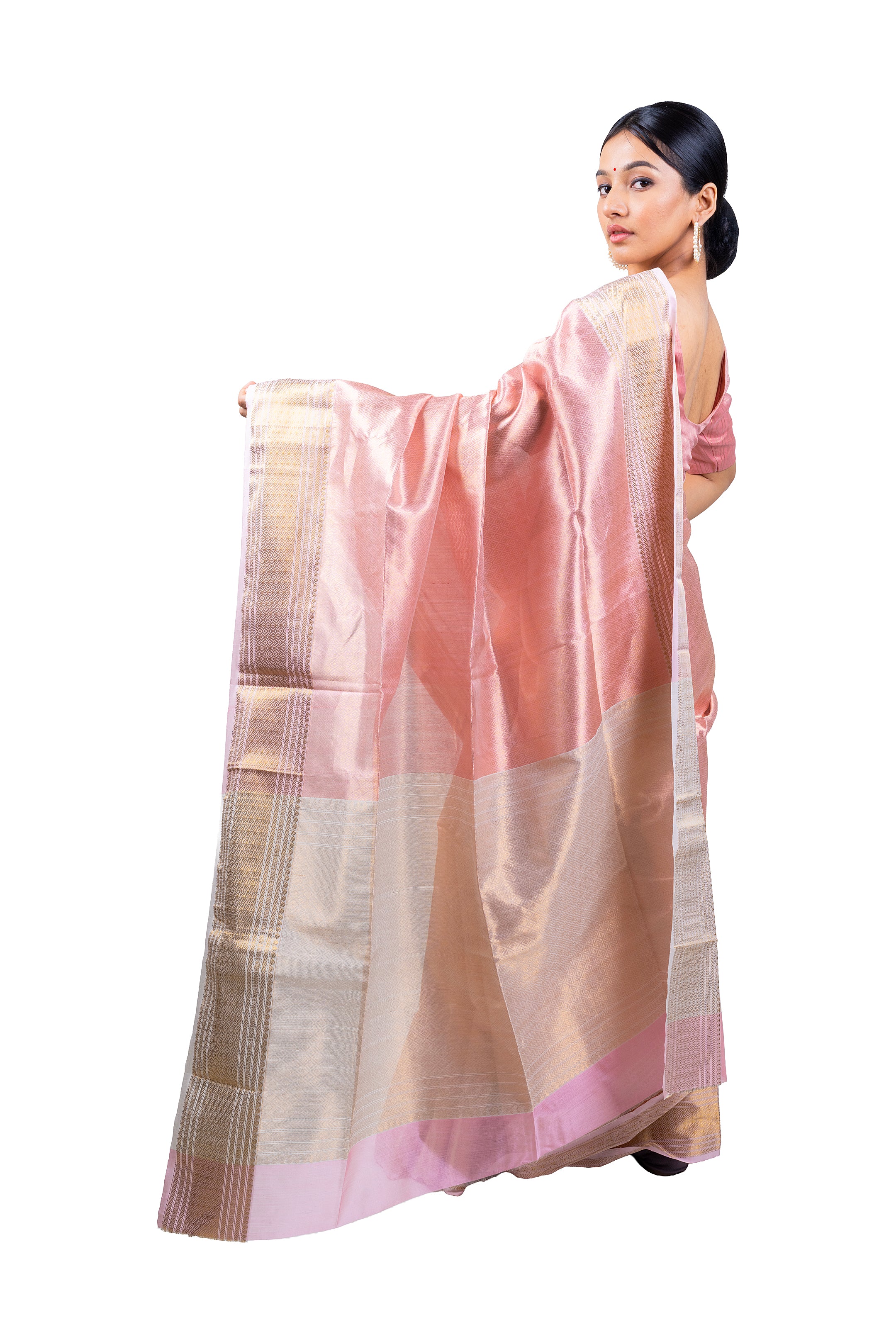 Woman wearing a pink and beige saree on a white background