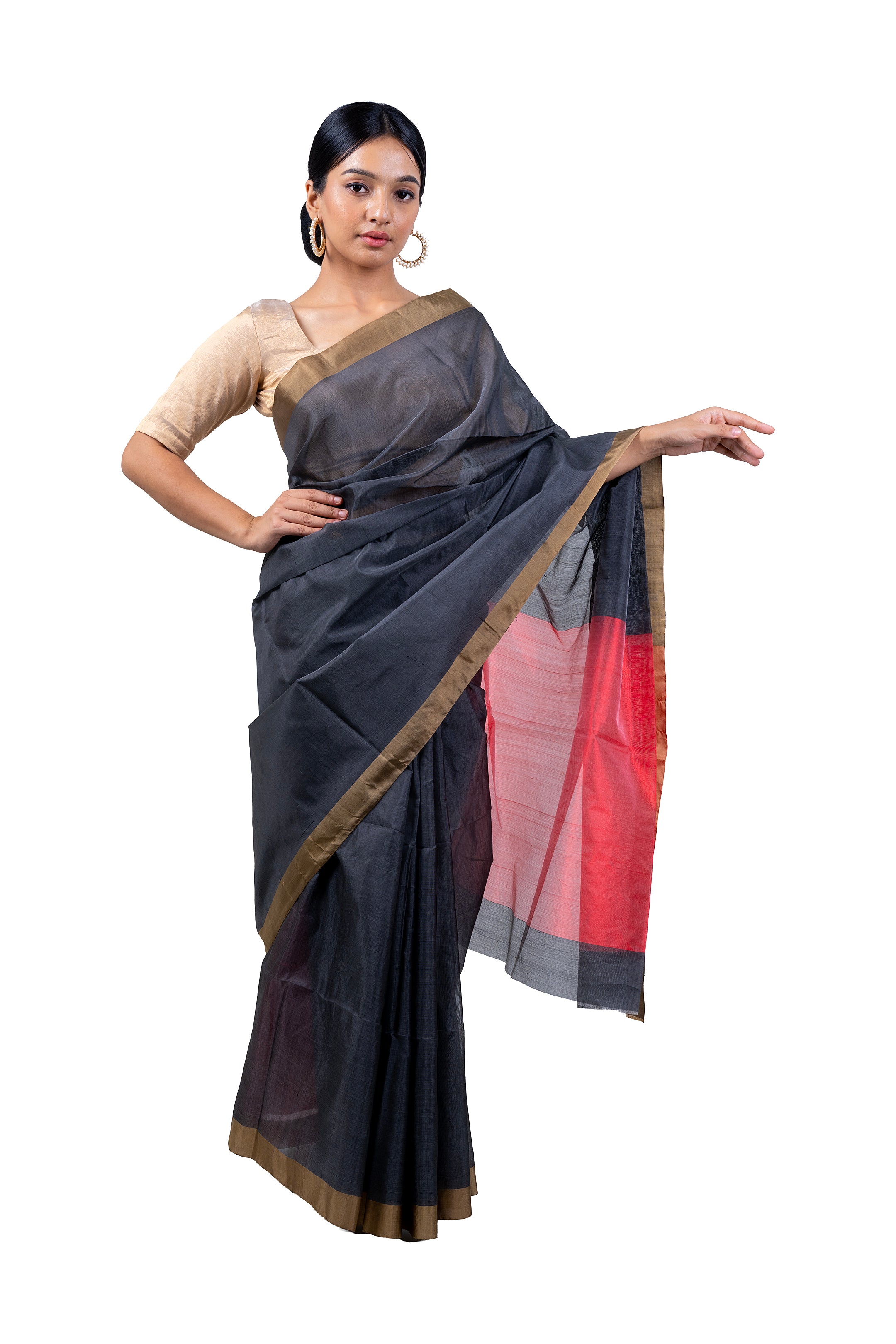 Woman wearing a traditional saree with a black and red design on a white background