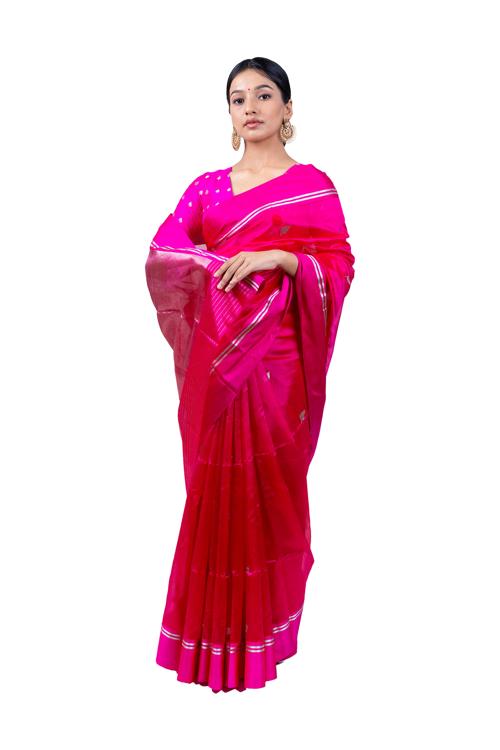 Woman wearing a bright pink saree with white patterns on a white background