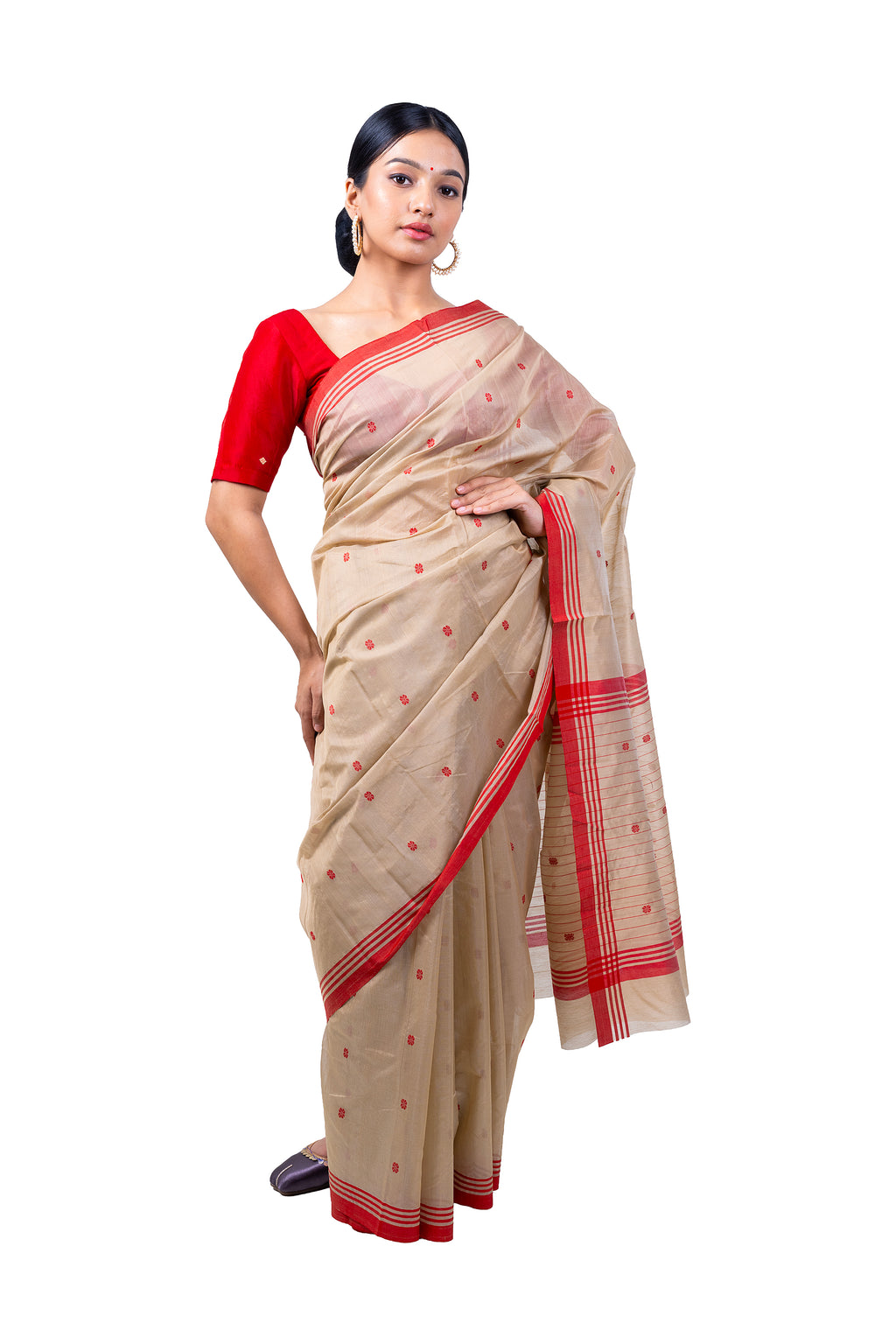 Woman wearing a beige saree with red border on a white background