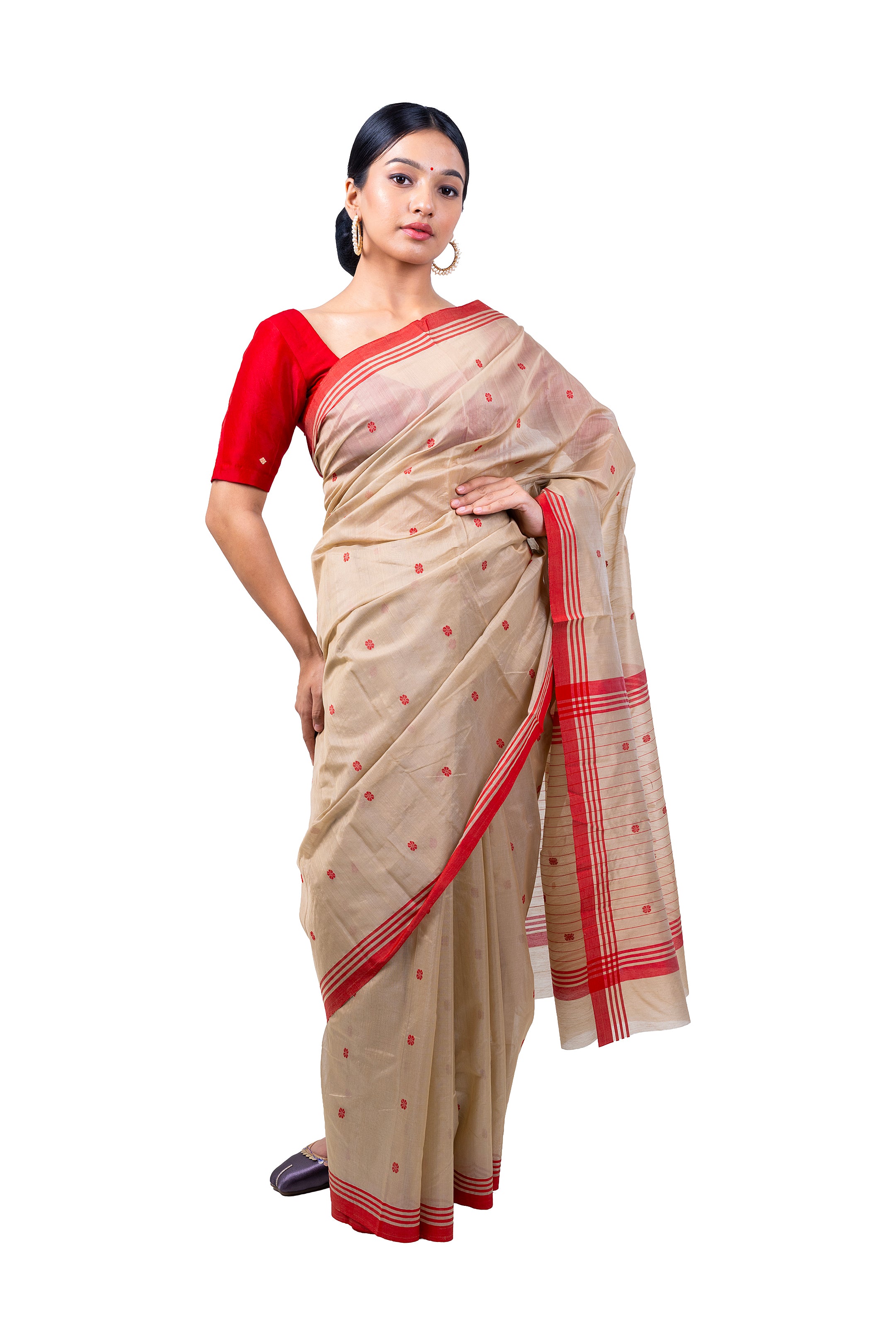 Woman wearing a beige saree with red border on a white background