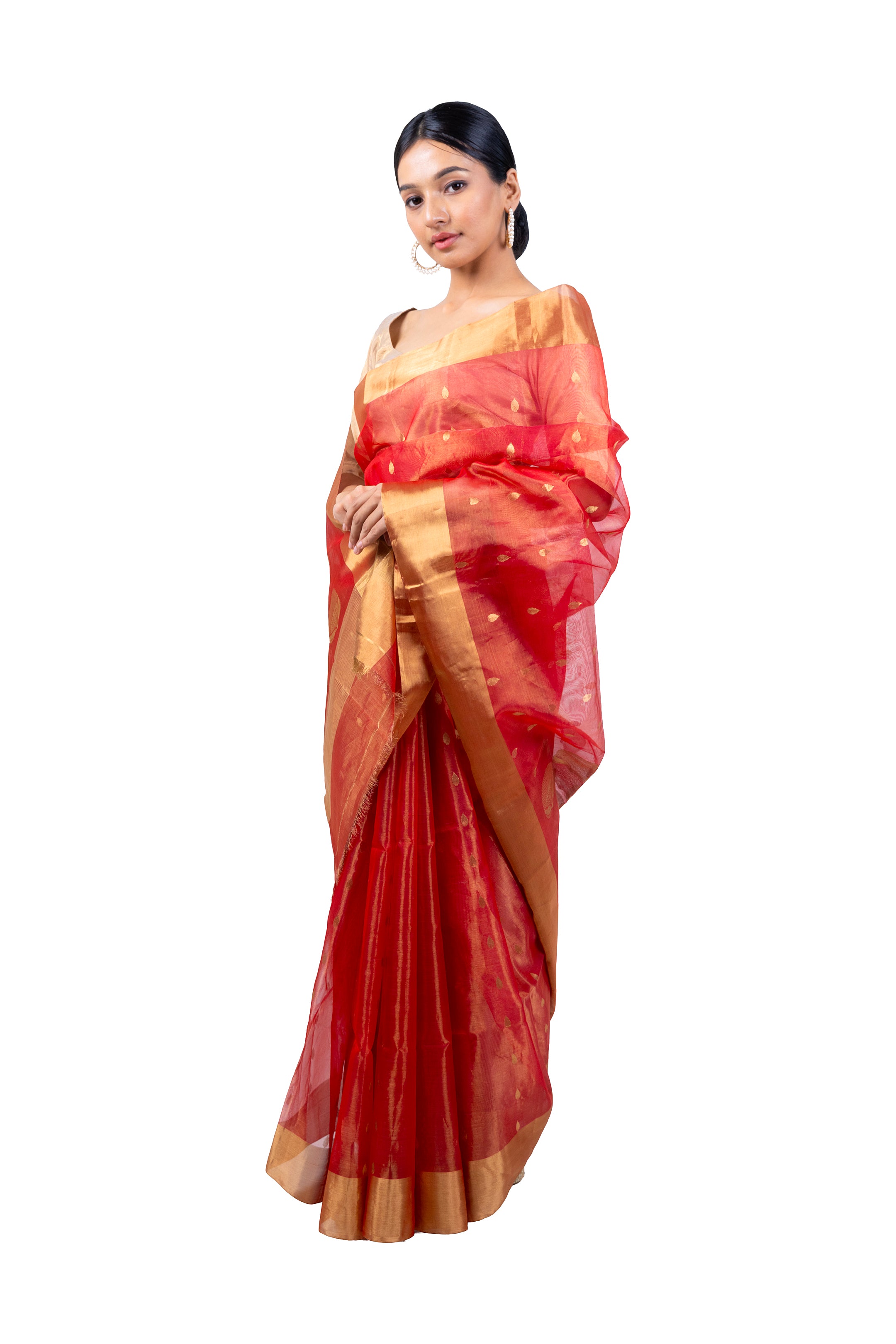 Woman wearing a red saree with gold border on a white background