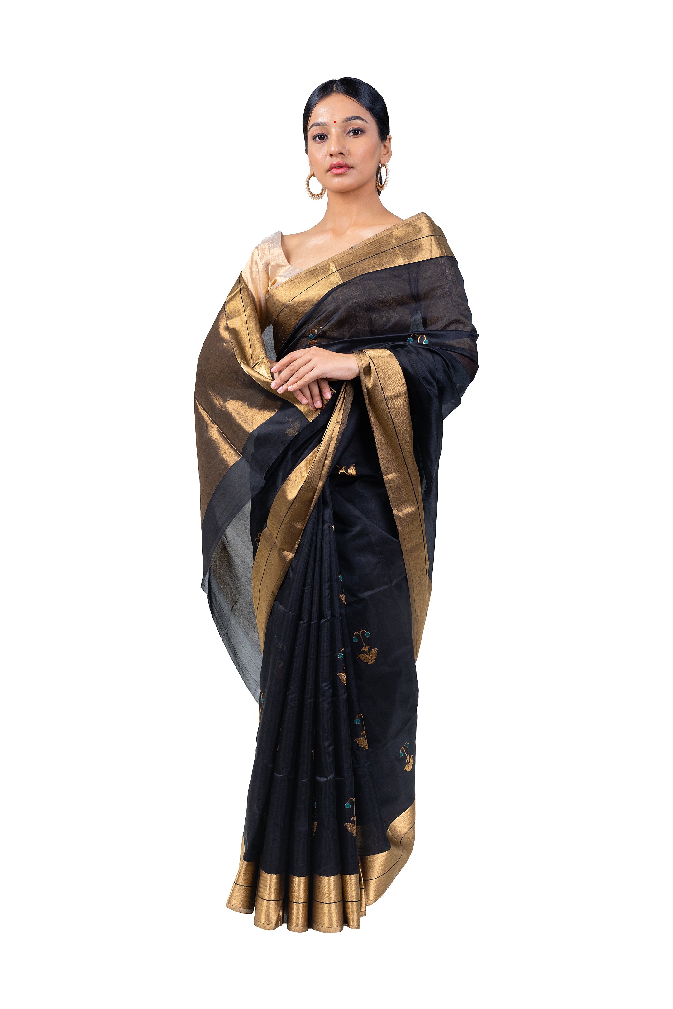 Woman wearing a black and gold saree on a white background