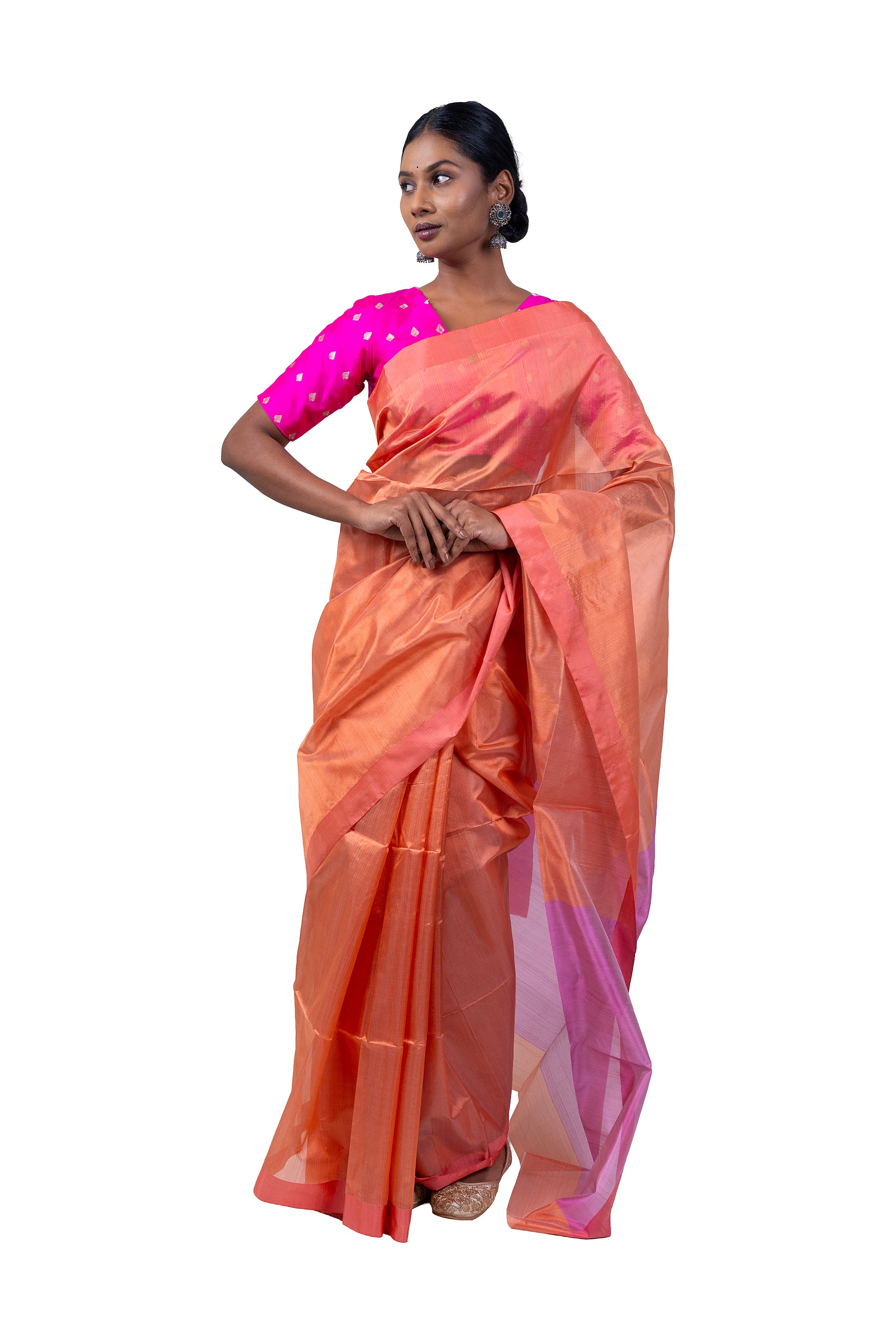 Woman wearing a peach saree with pink blouse on a white background