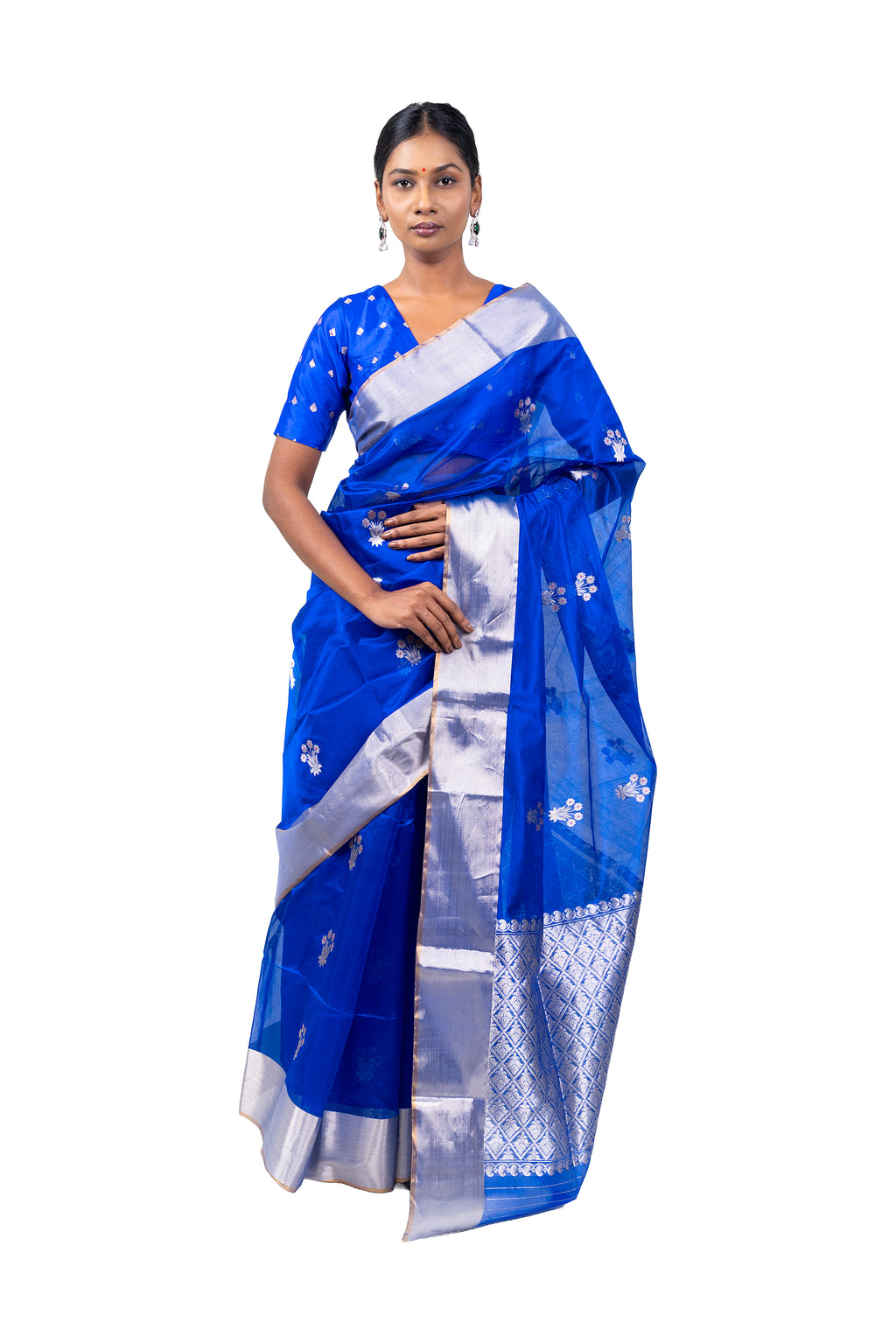 Woman wearing a blue saree with white patterns on a white background