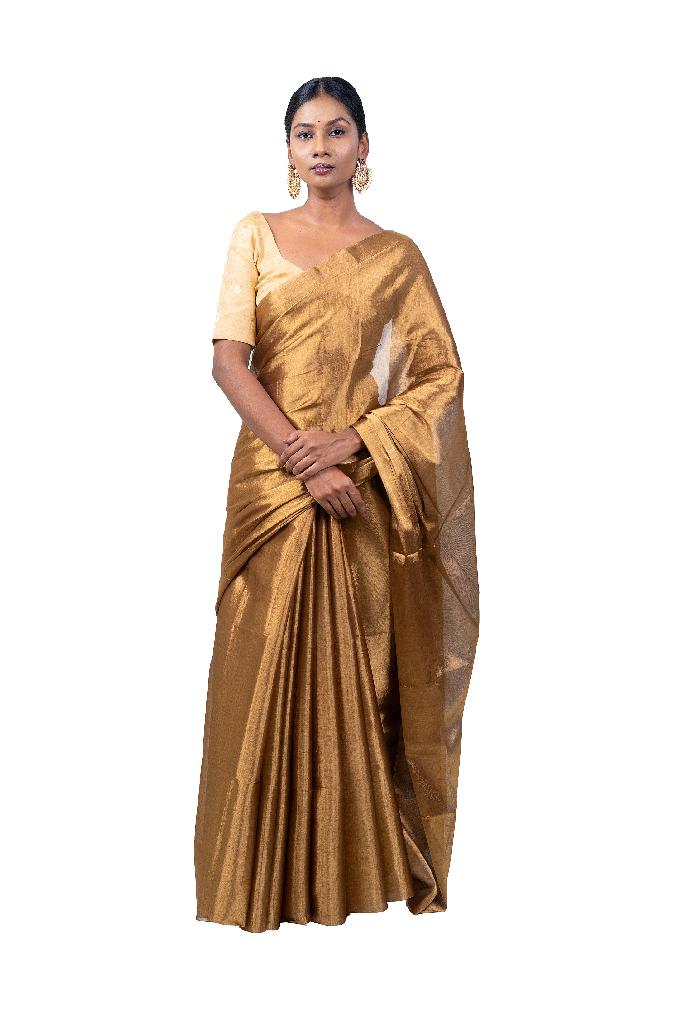 Woman wearing a gold saree on a white background