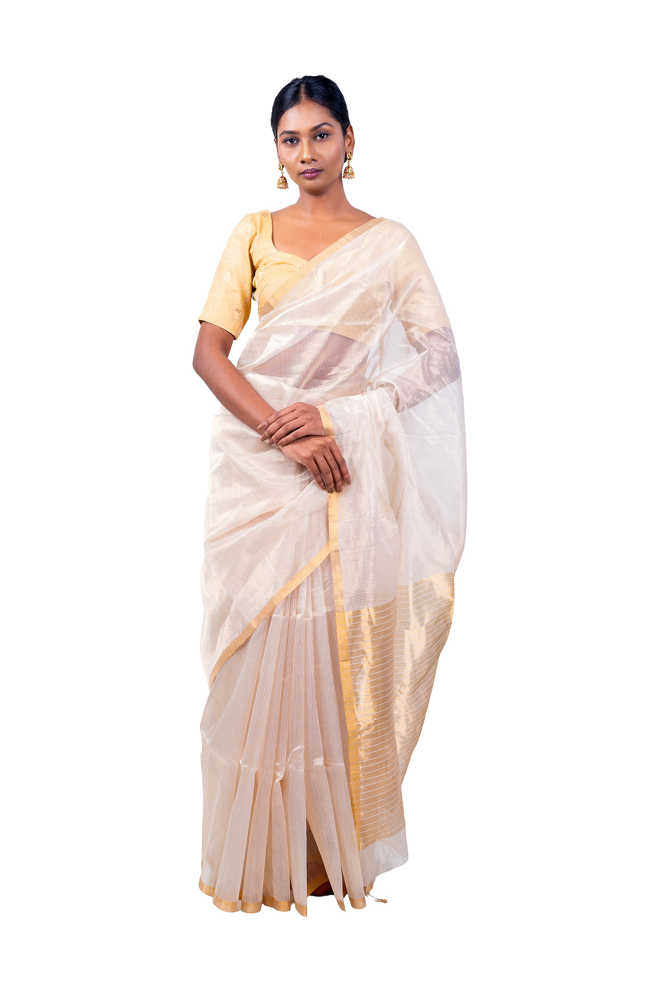 Woman wearing a white saree with gold border on a white background