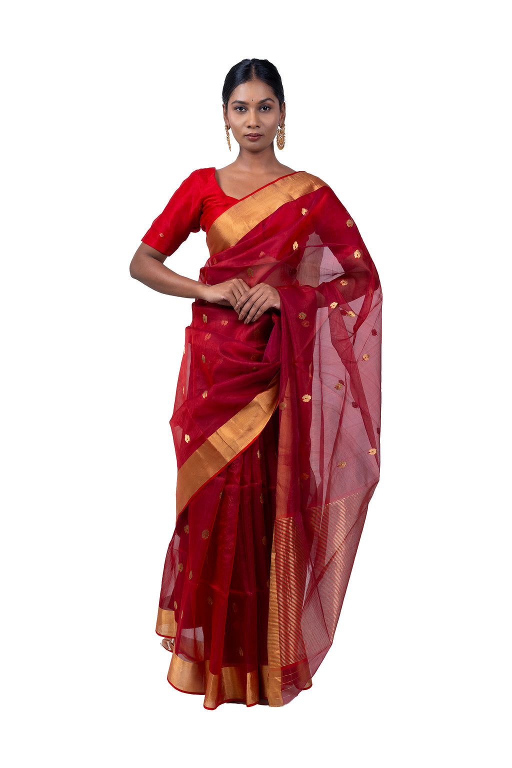 Woman wearing a red saree with gold border on a white background