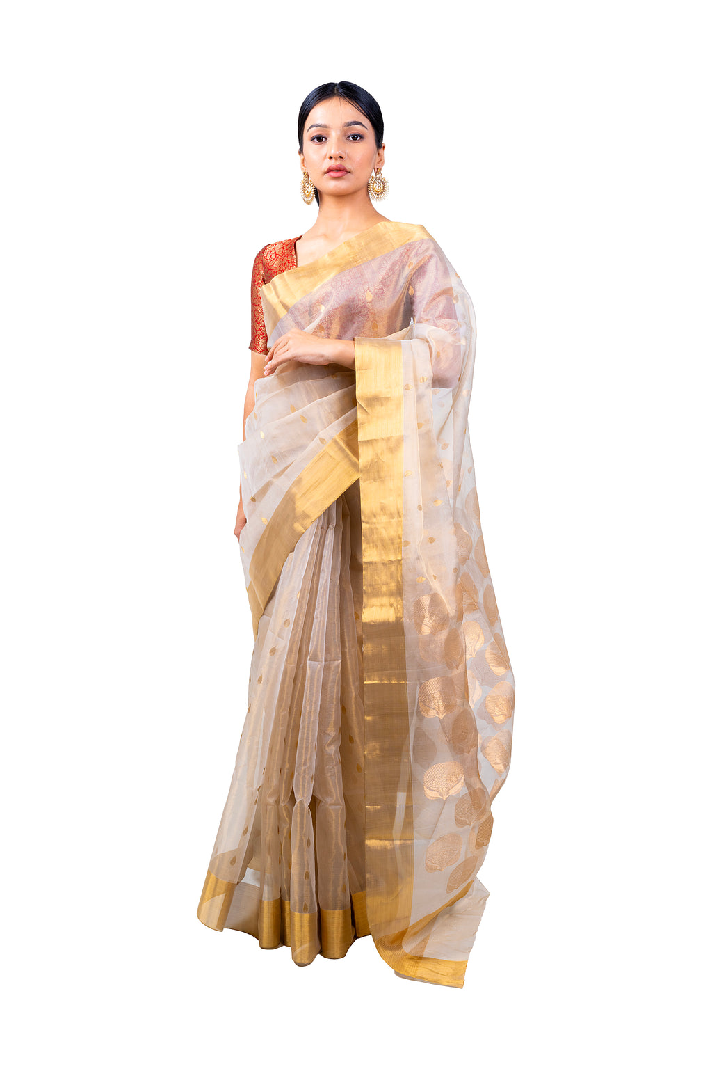 Woman wearing a traditional saree with a white and gold pattern on a white background