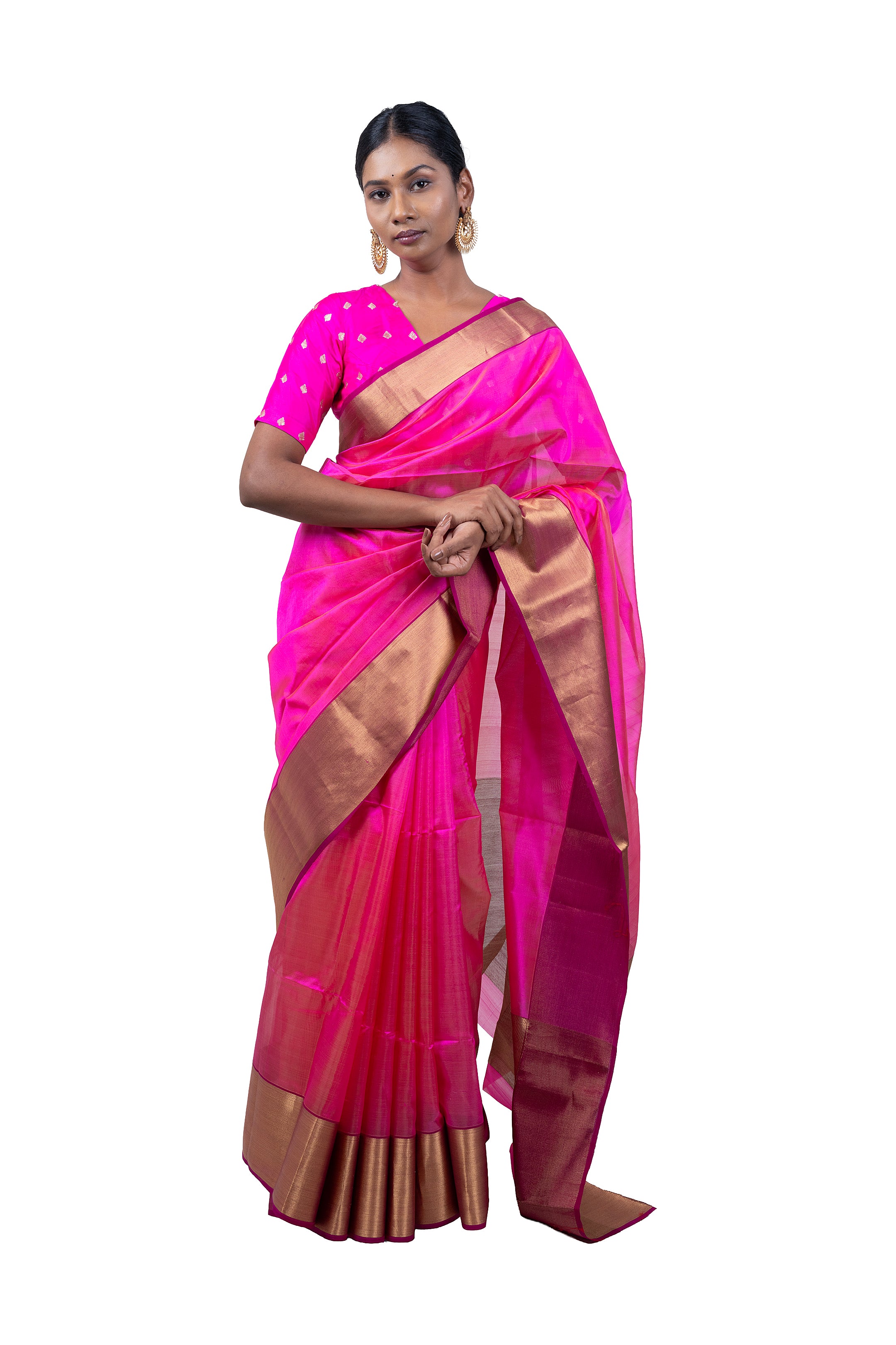 Woman wearing a pink saree with a gold border on a white background