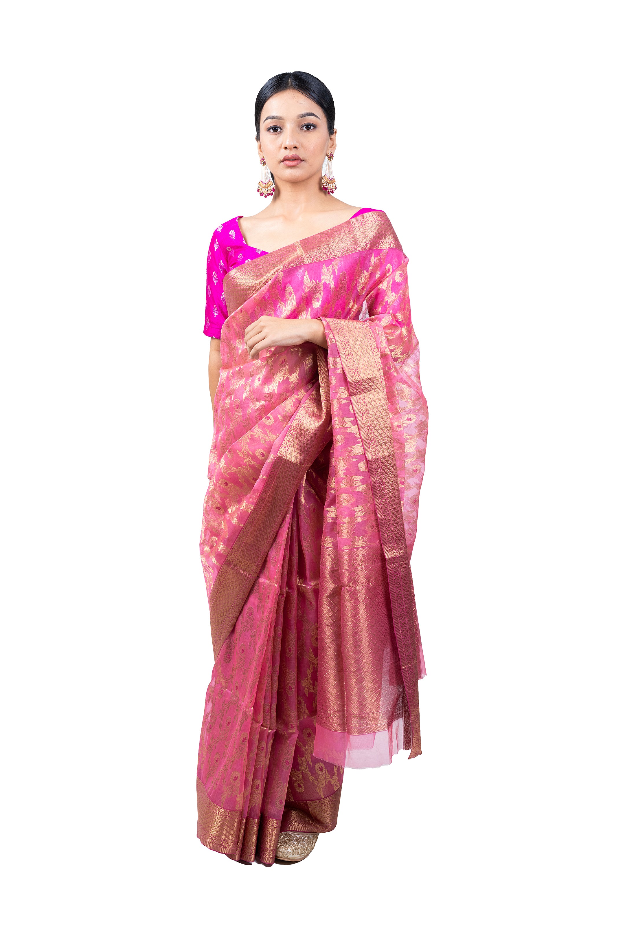 Woman wearing a pink saree with a white background