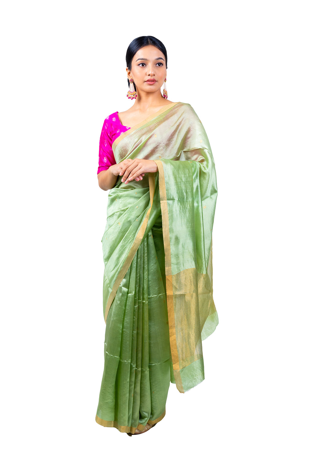 Woman wearing a light green saree with a pink blouse on a white background