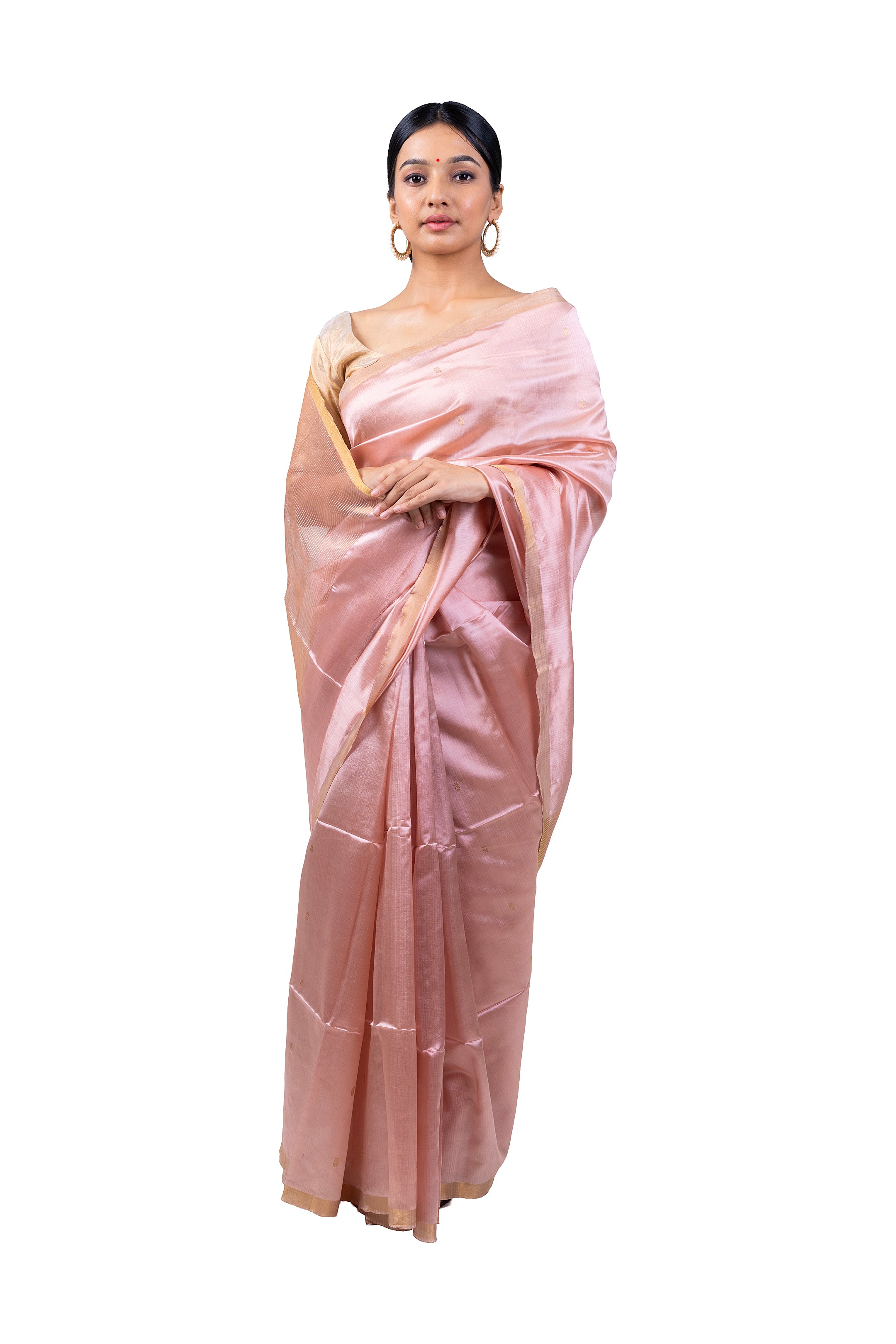 Woman wearing a light pink saree with a white background