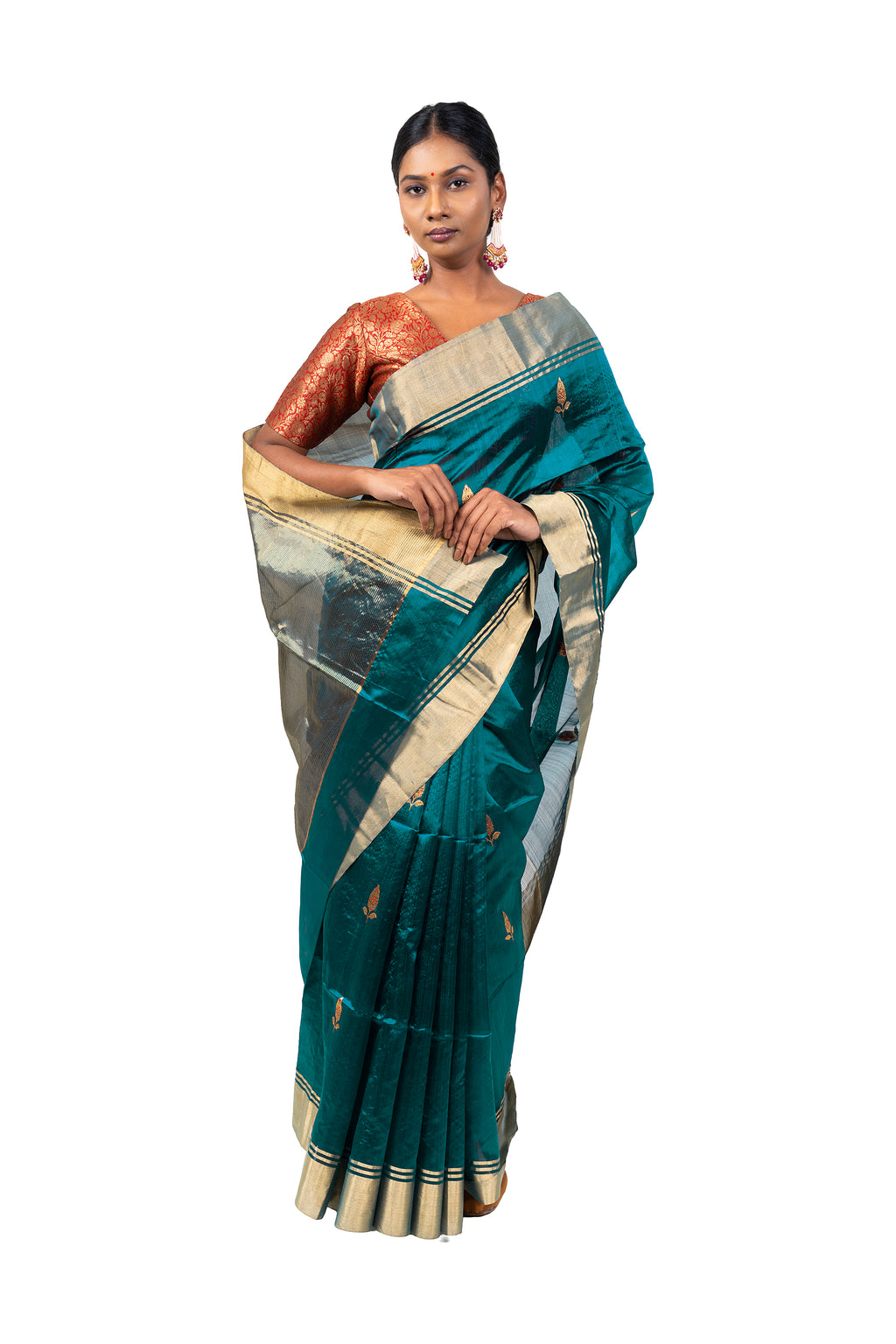 Woman wearing a teal saree with gold and beige patterns on a white background