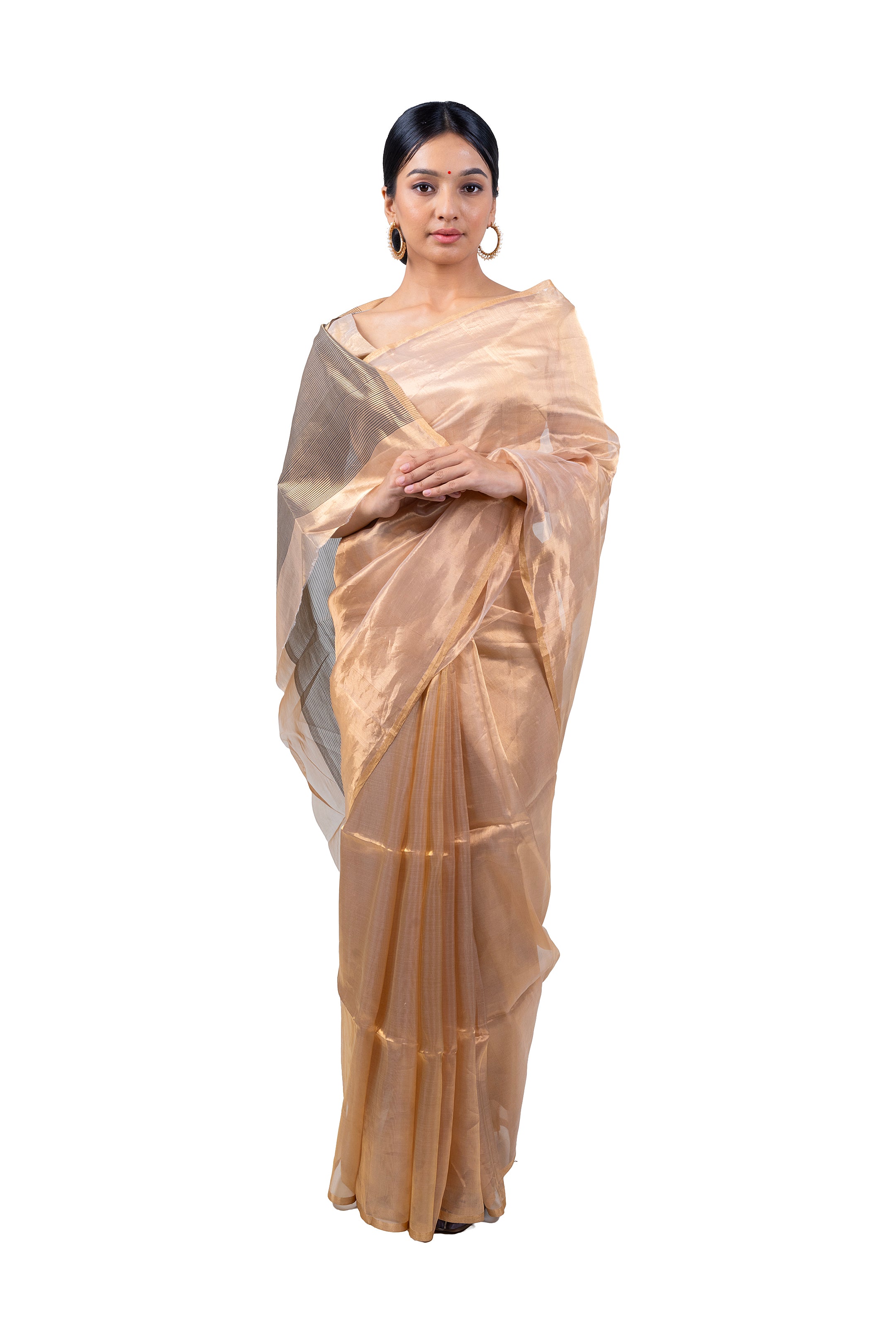 Woman wearing a beige saree with a white background