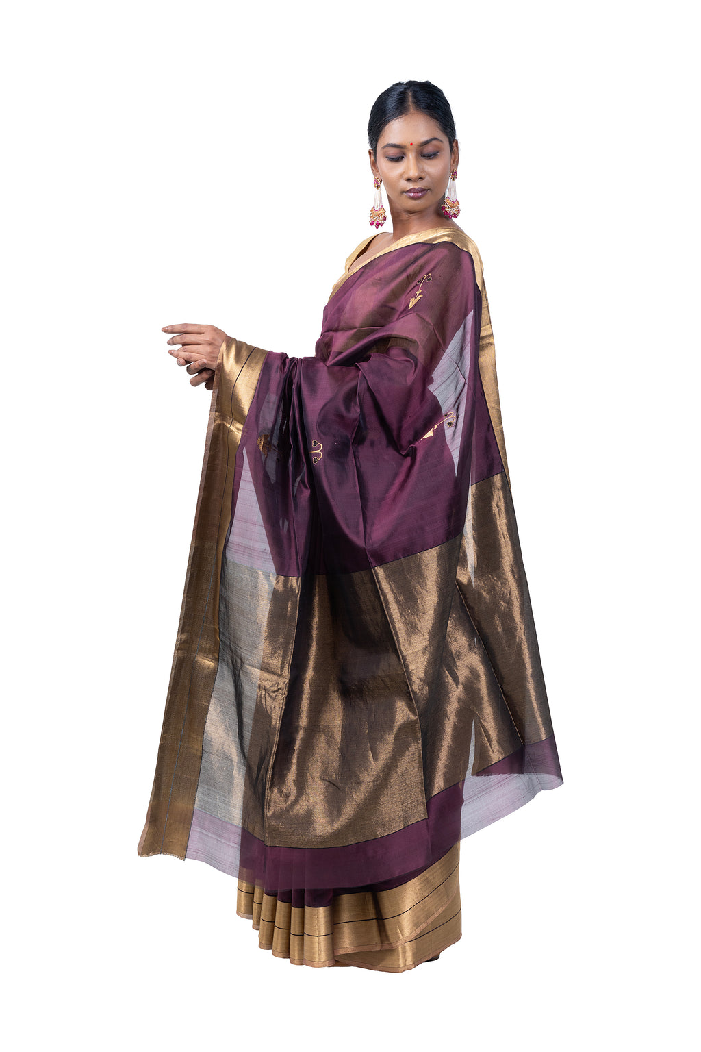 Woman wearing a traditional maroon and gold saree on a white background