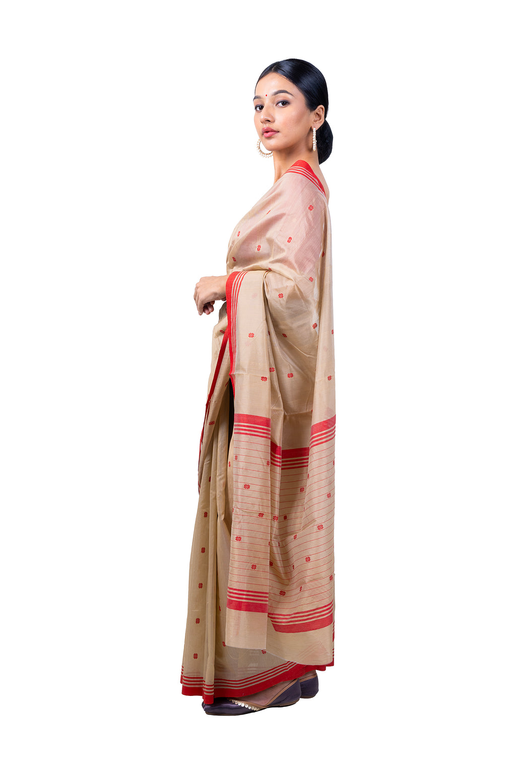 Woman wearing a beige saree with red accents on a white background
