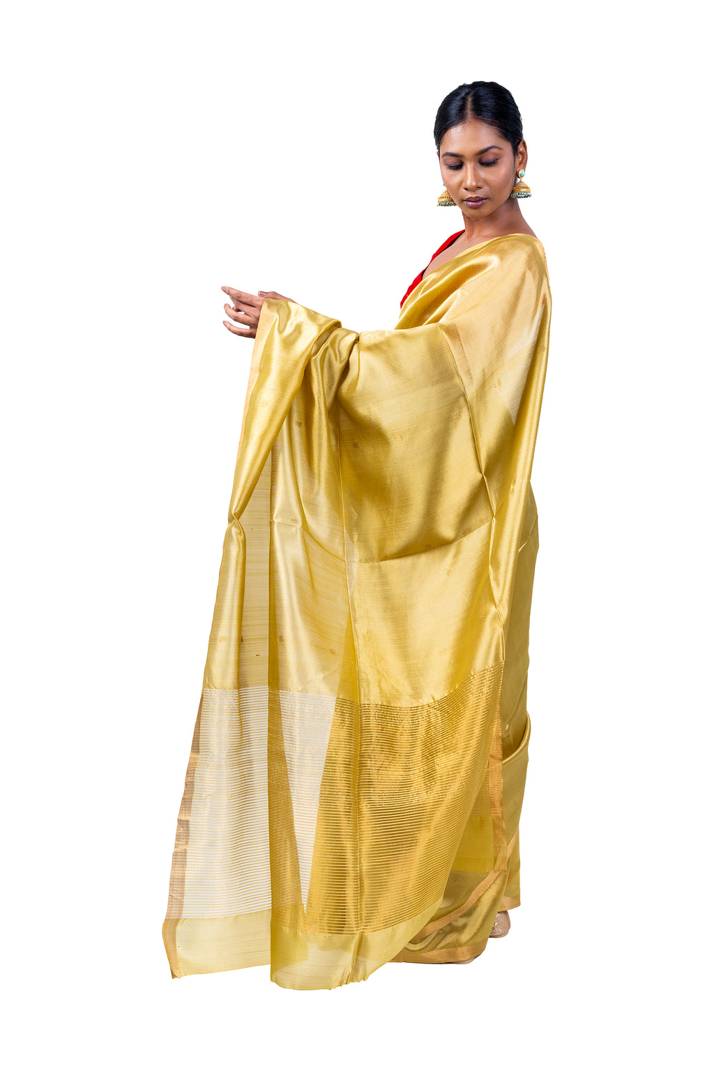Woman wearing a gold saree with a white background