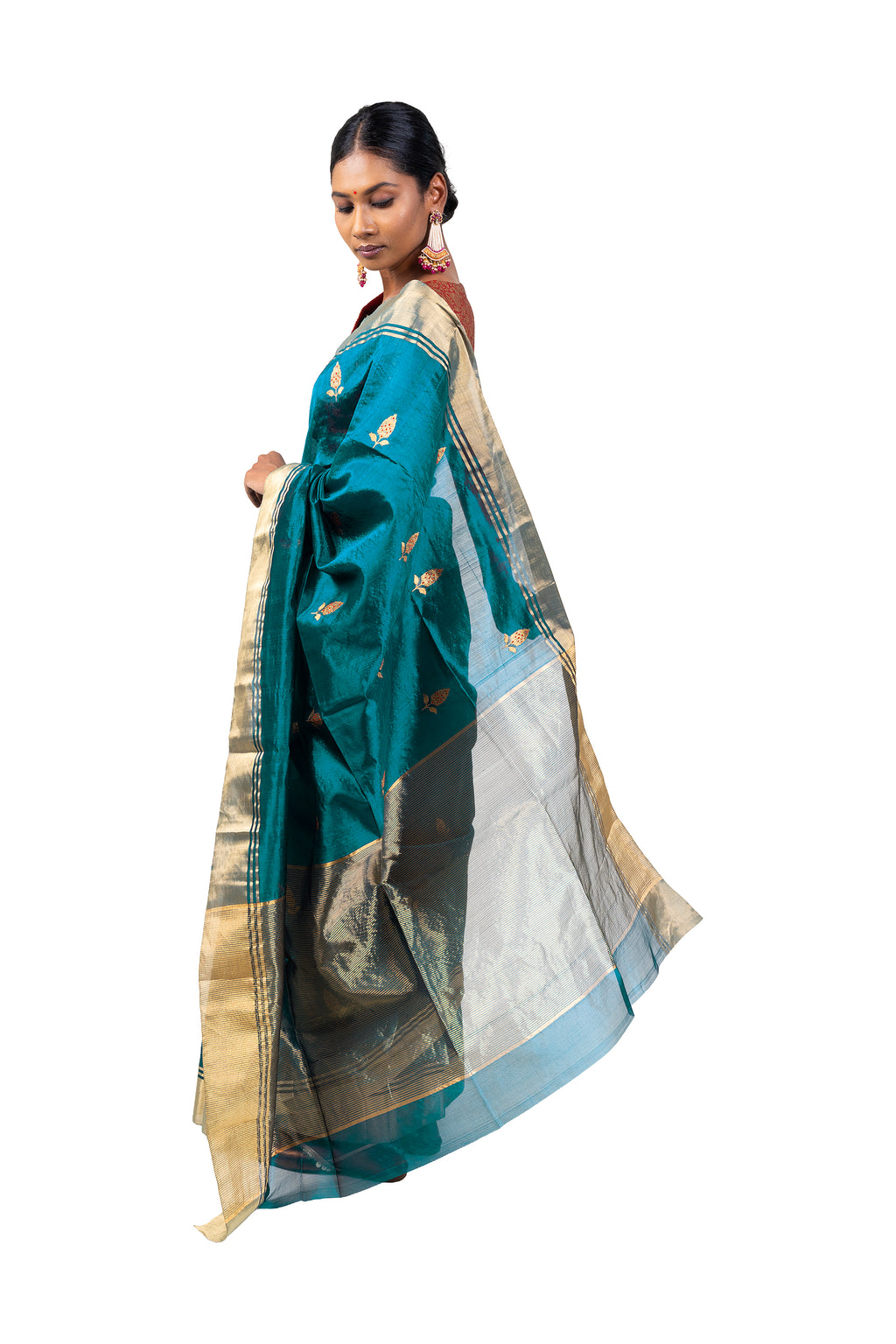 Woman wearing a teal saree with gold and white patterns on a white background