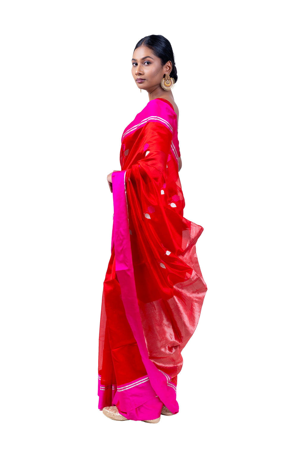 Woman wearing a red and pink saree on a white background