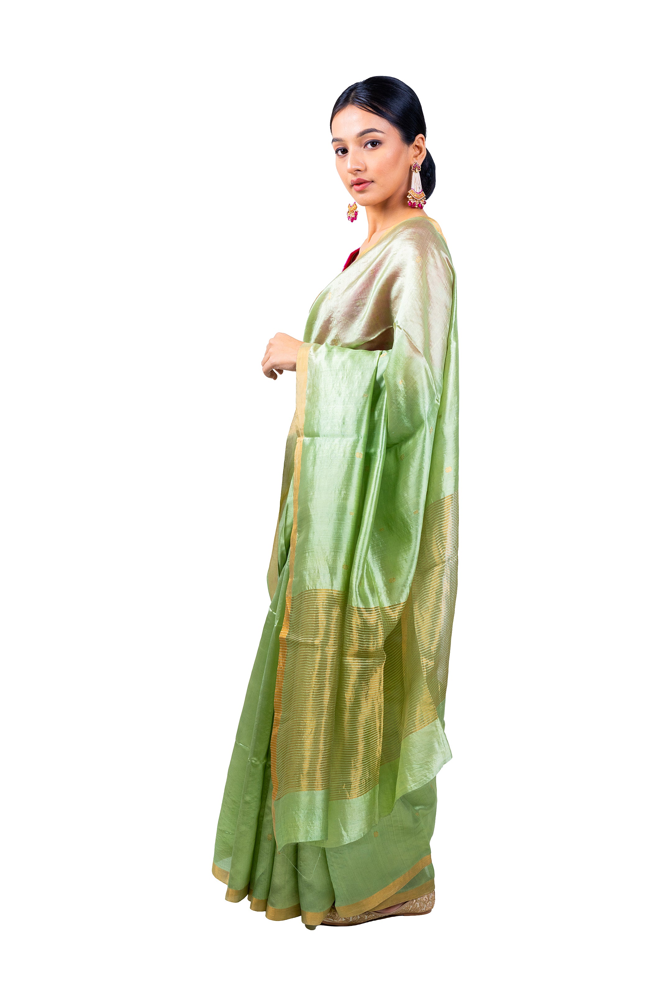 Woman wearing a light green saree with a white background