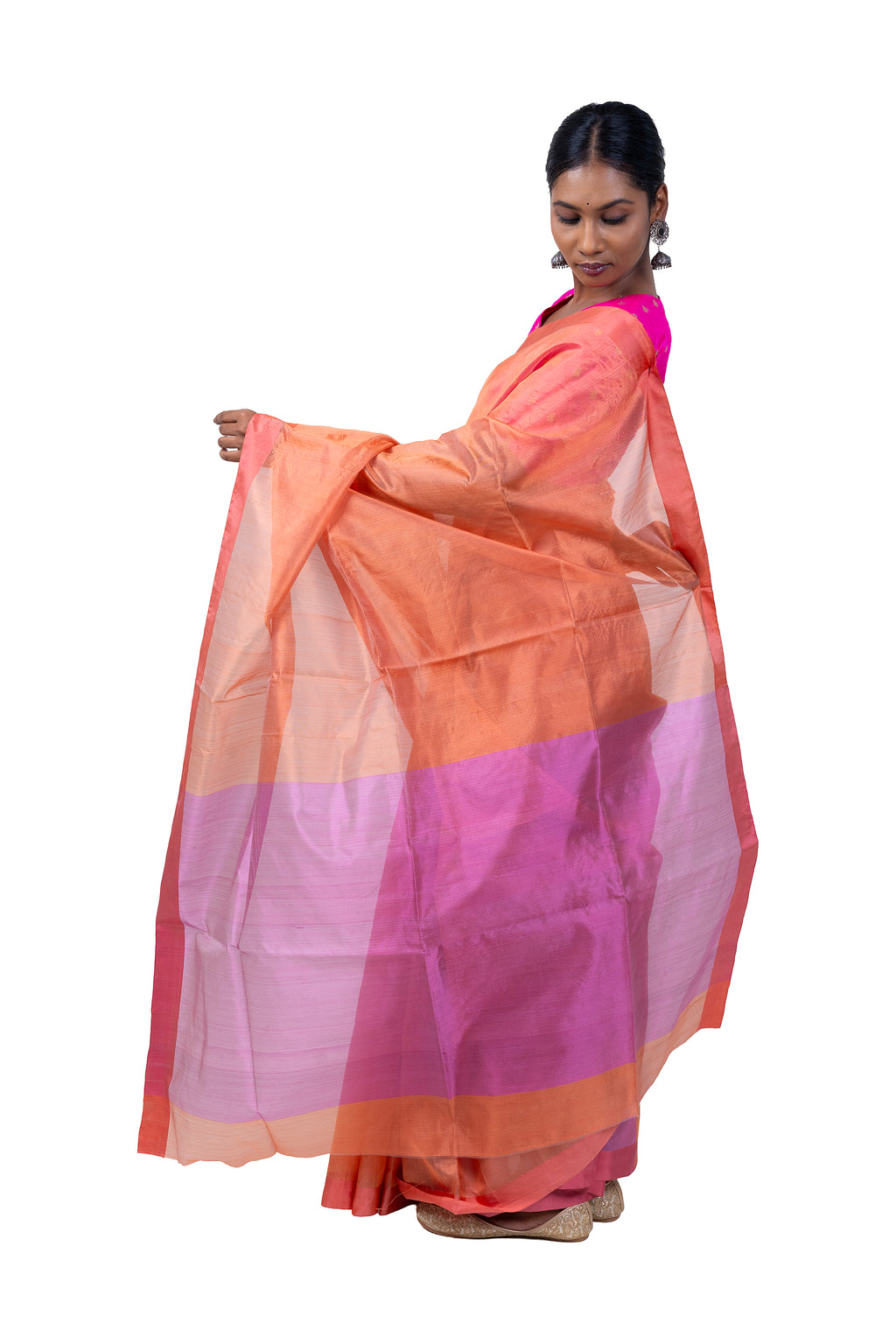 Woman wearing a peach and pink saree on a white background