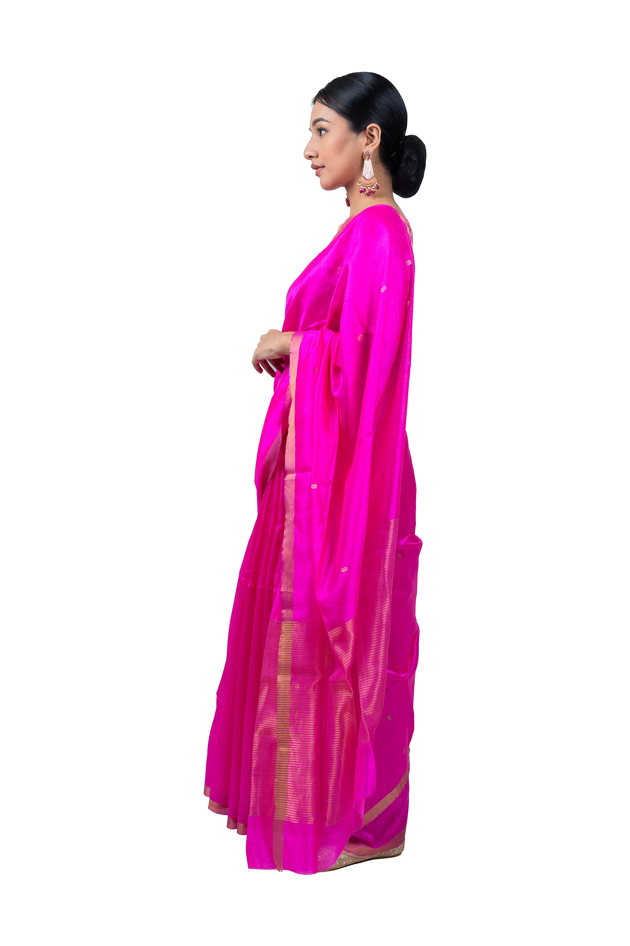 Woman wearing a bright pink saree with a white background