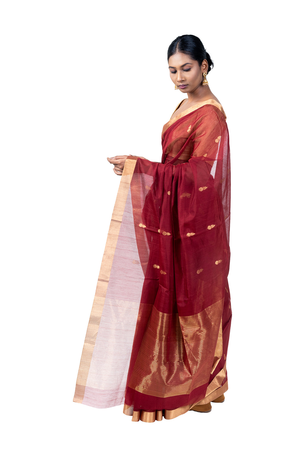 Woman wearing a traditional maroon saree with a white blouse on a white background