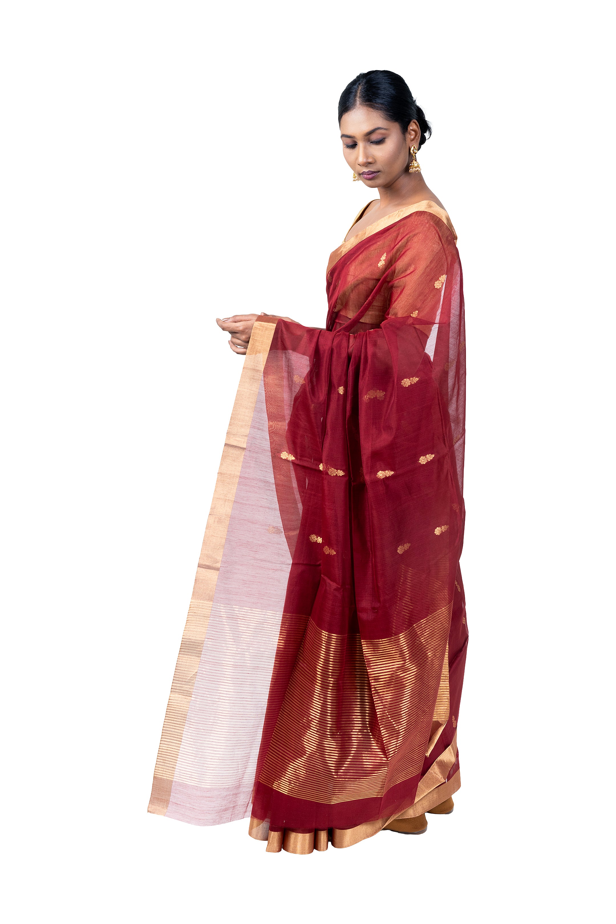 Woman wearing a traditional maroon saree with a white blouse on a white background