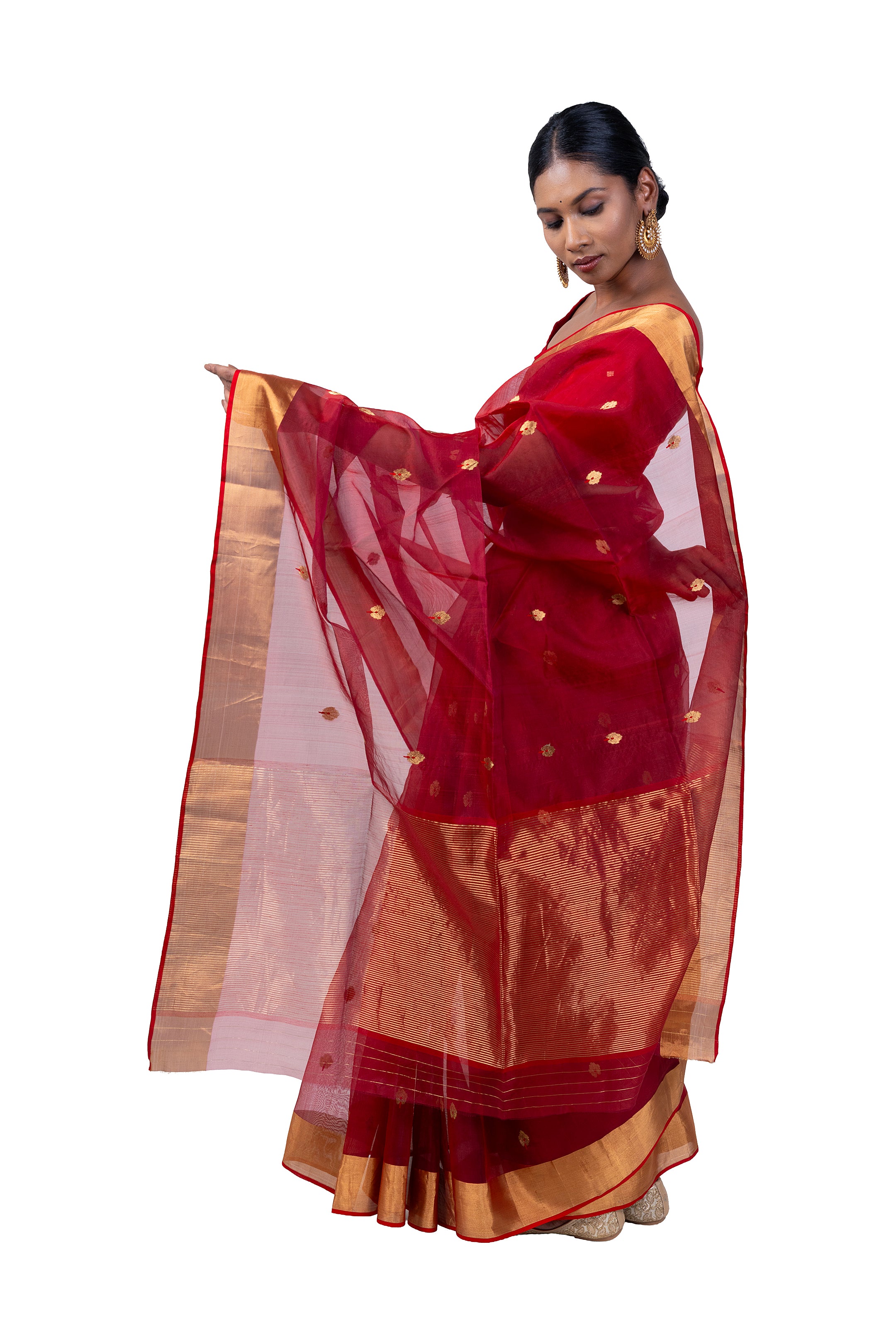 Woman wearing a red and gold saree with a white background