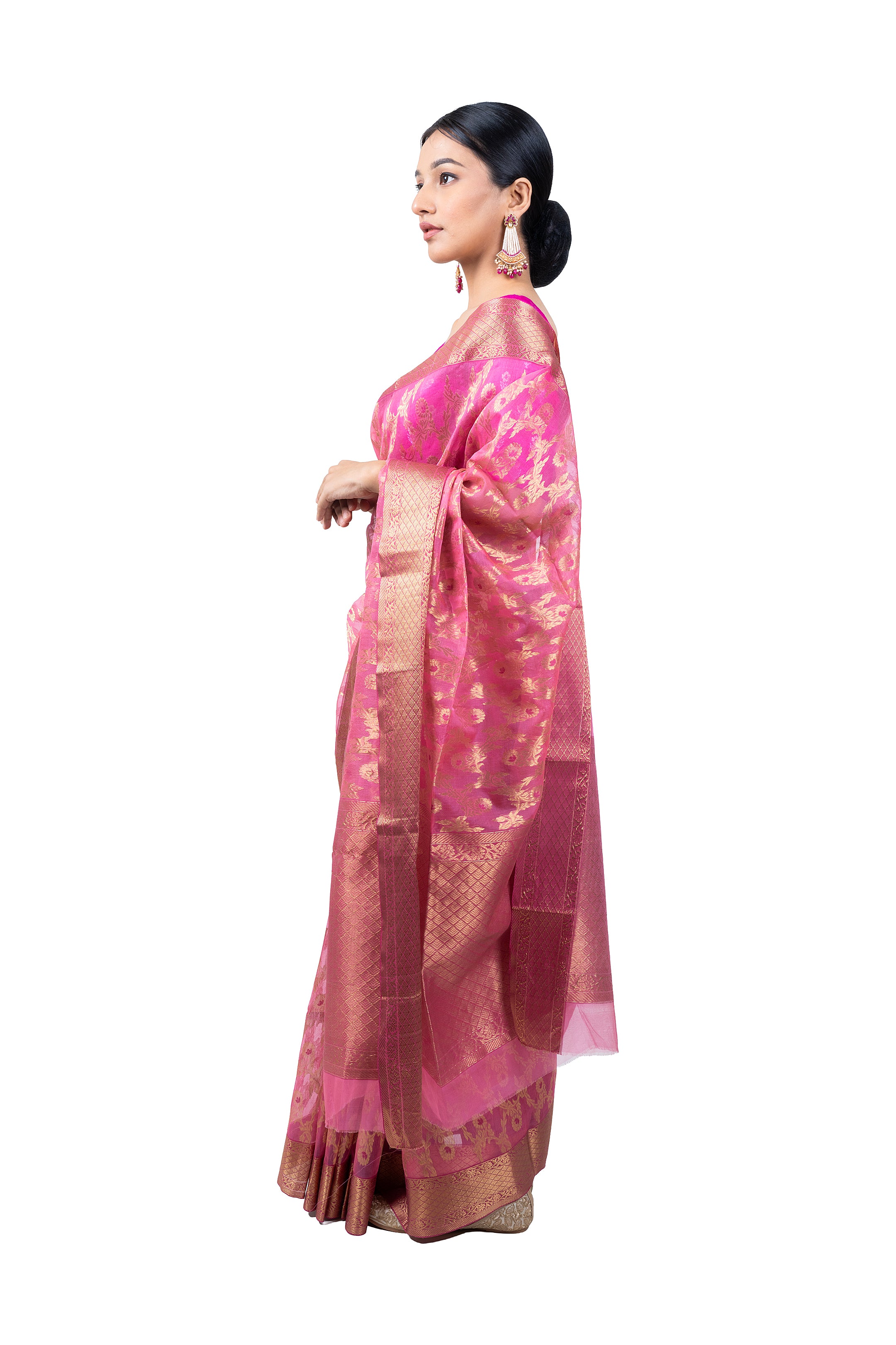 Woman wearing a pink saree with a white background