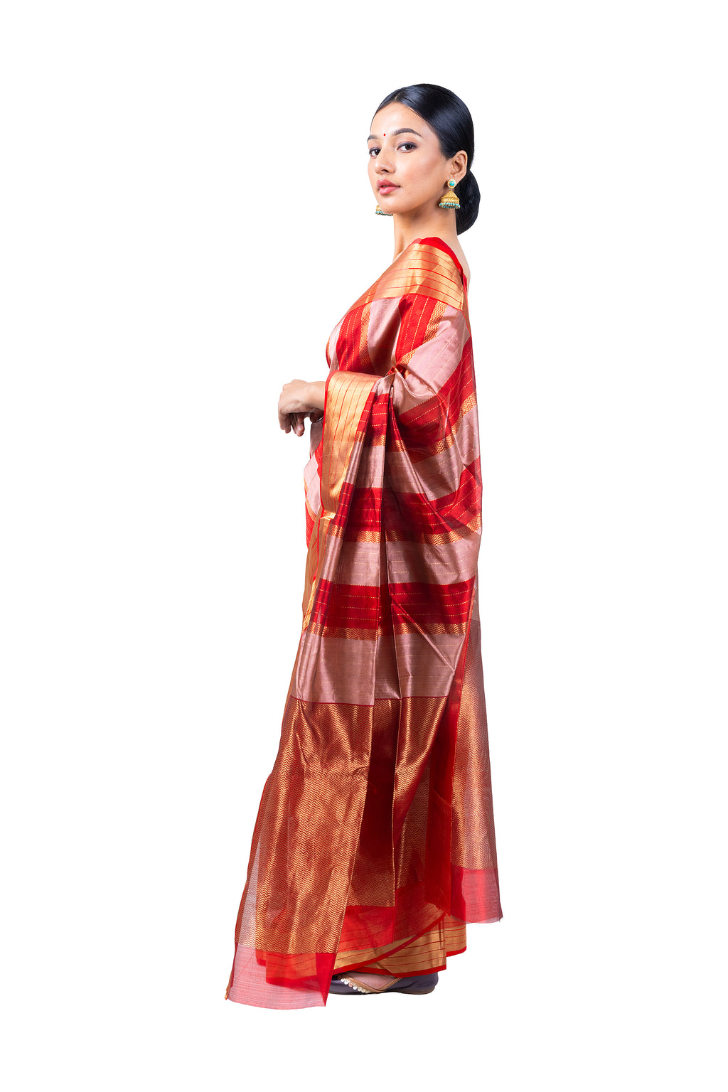 Woman wearing a red and gold saree on a white background