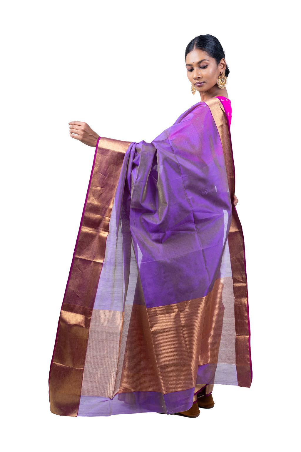 Woman wearing a purple saree with a brown border on a white background