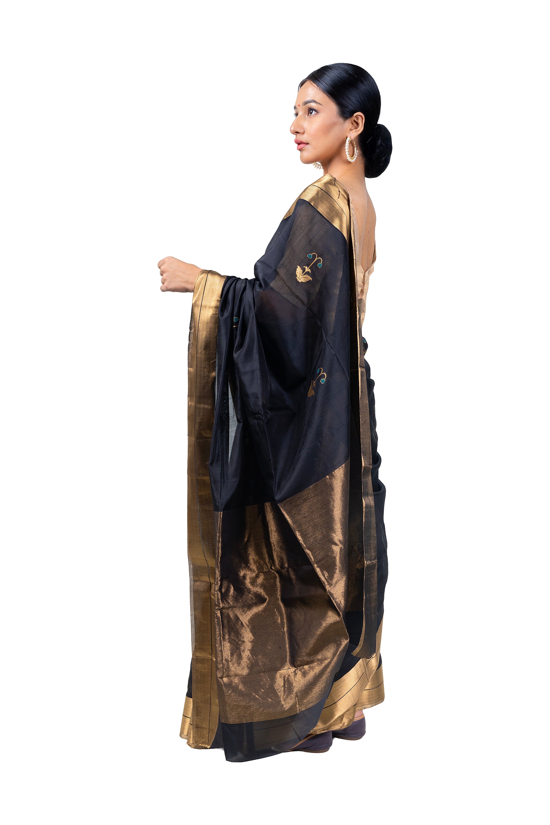 Woman wearing a black and gold saree on a white background
