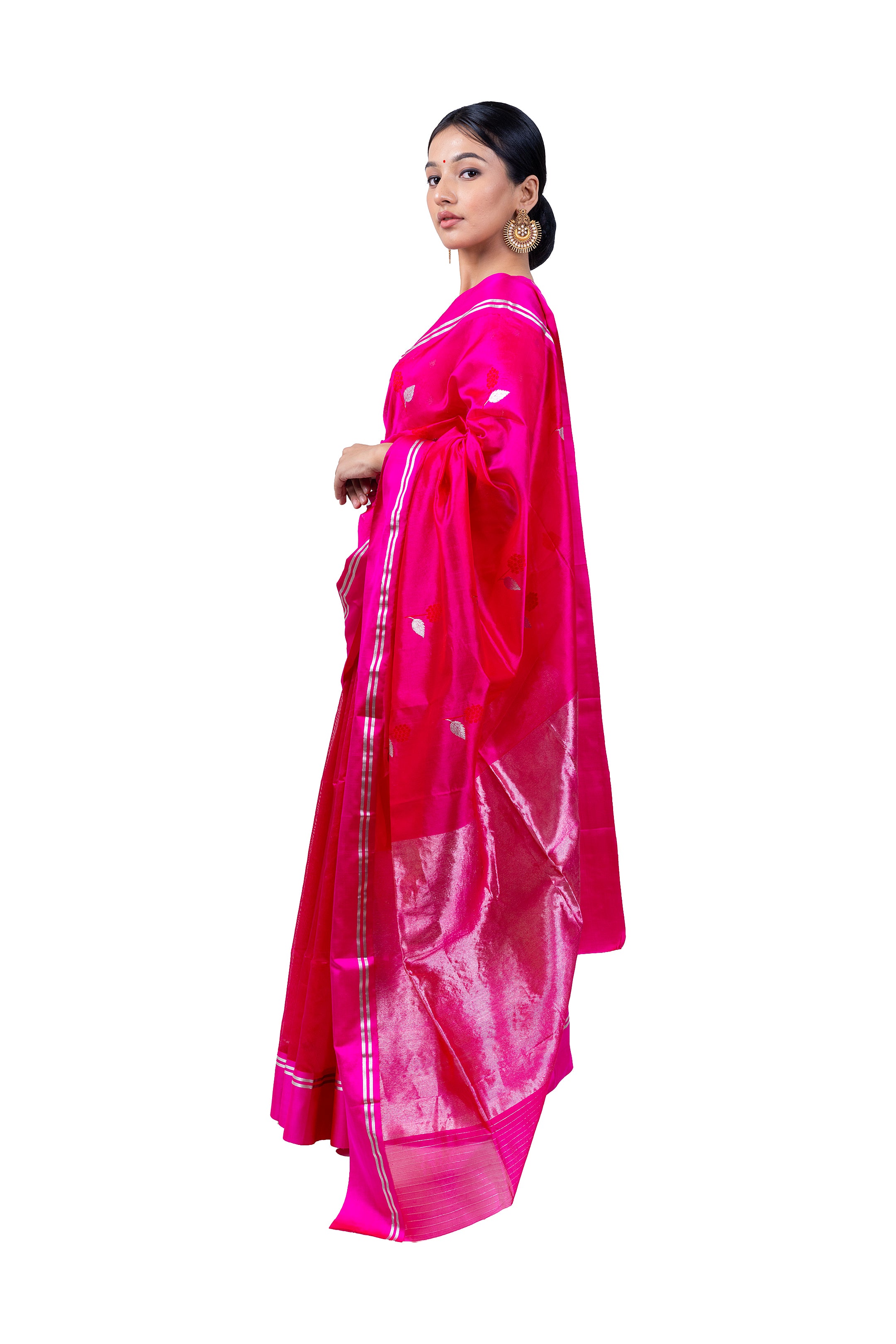 Woman wearing a bright pink saree with a white border on a white background
