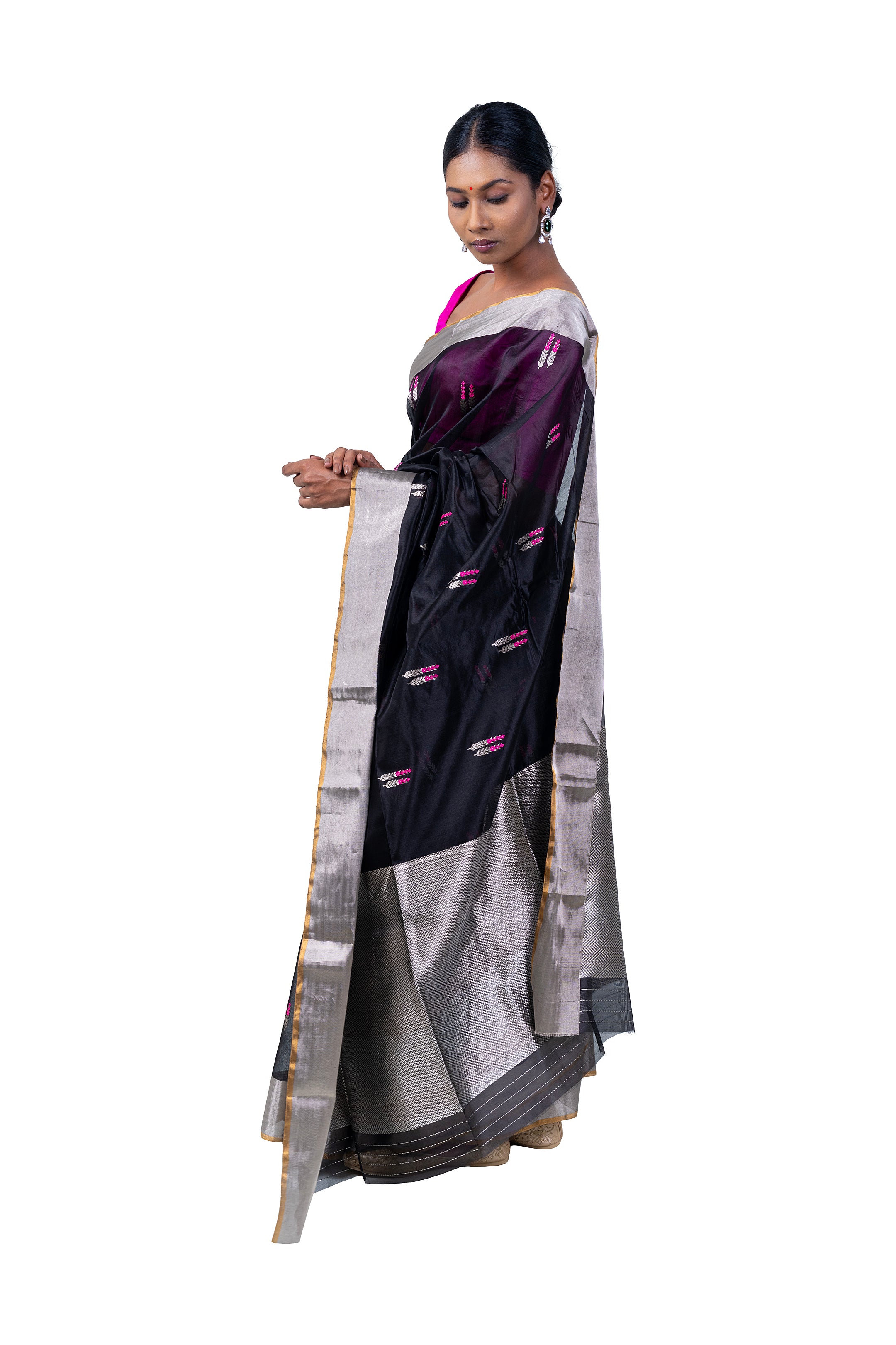 Woman wearing a traditional saree with a white and black pattern on a white background