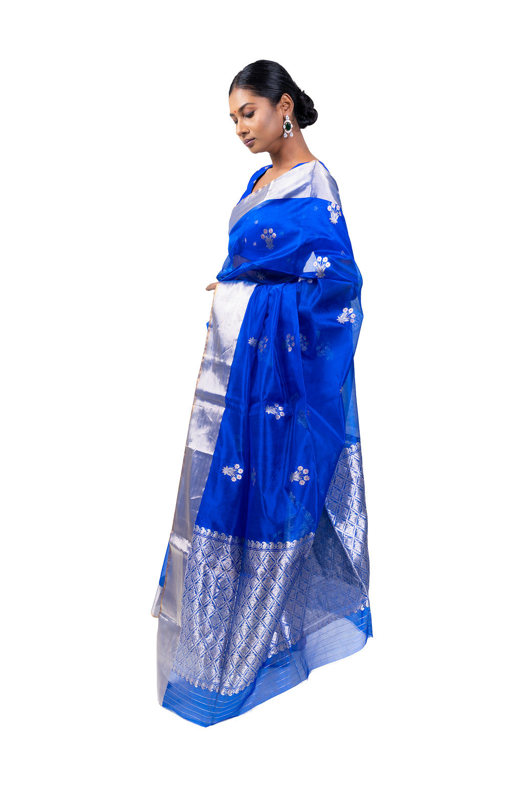 Woman wearing a blue and white saree with a white background