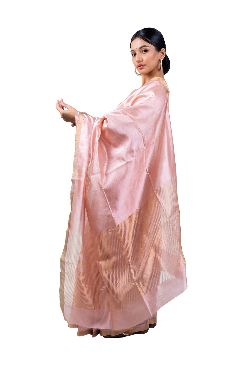 Woman wearing a light pink saree with a white background