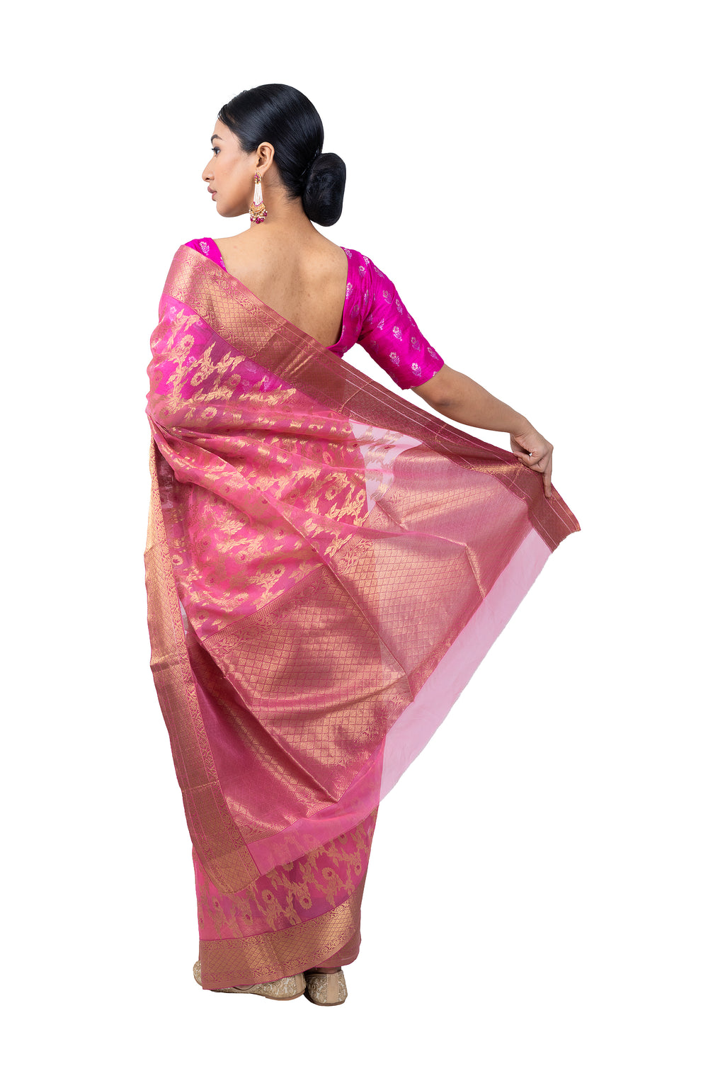 Woman wearing a pink saree with a white background