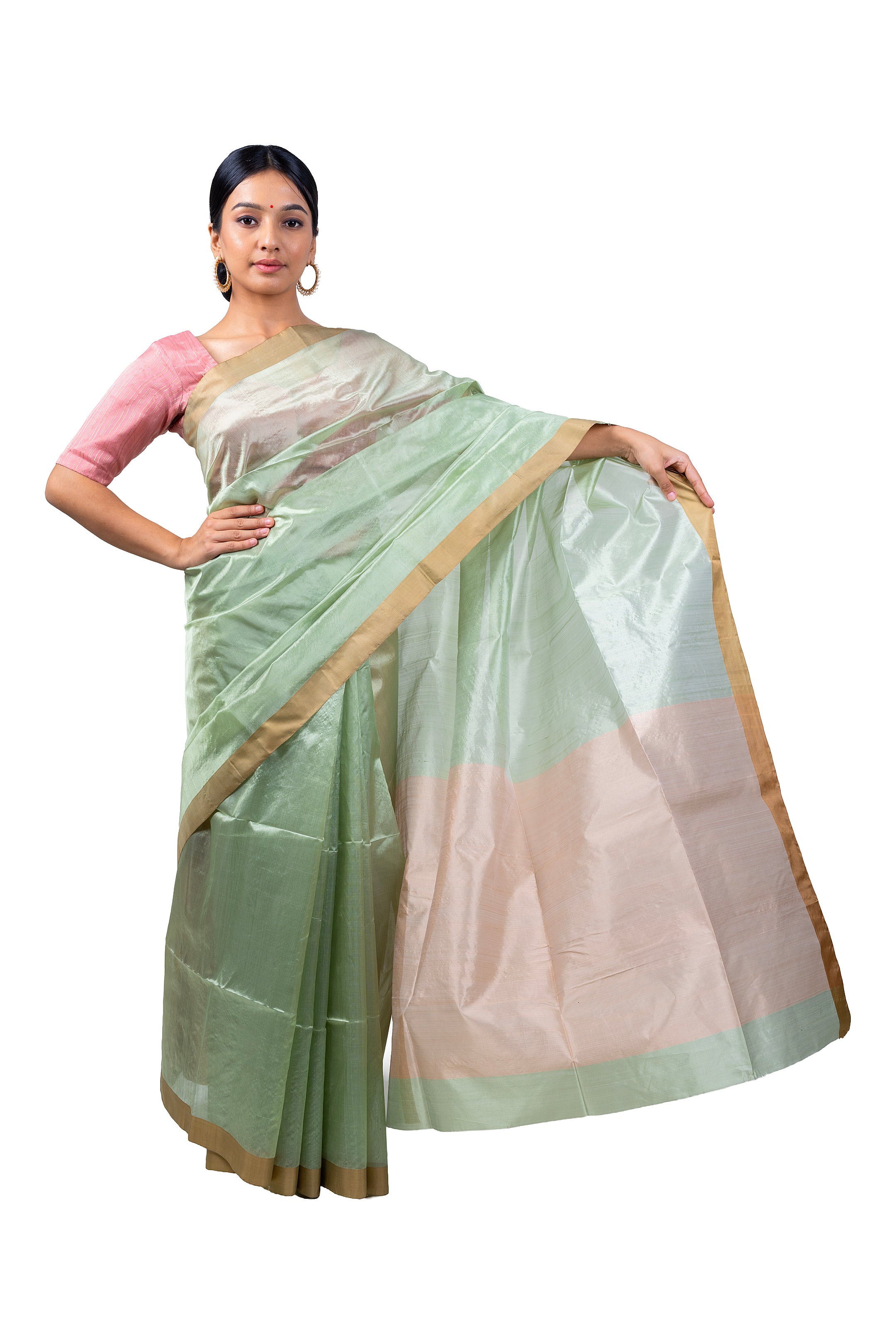 Woman wearing a light green saree with a pink blouse on a white background