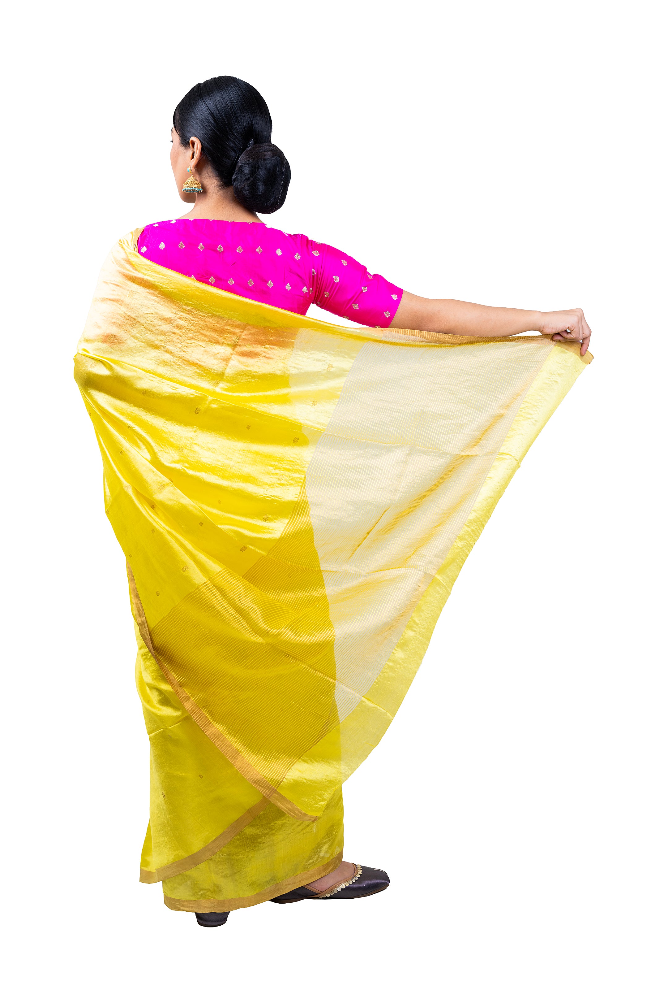 Woman wearing a yellow saree with a pink blouse on a white background