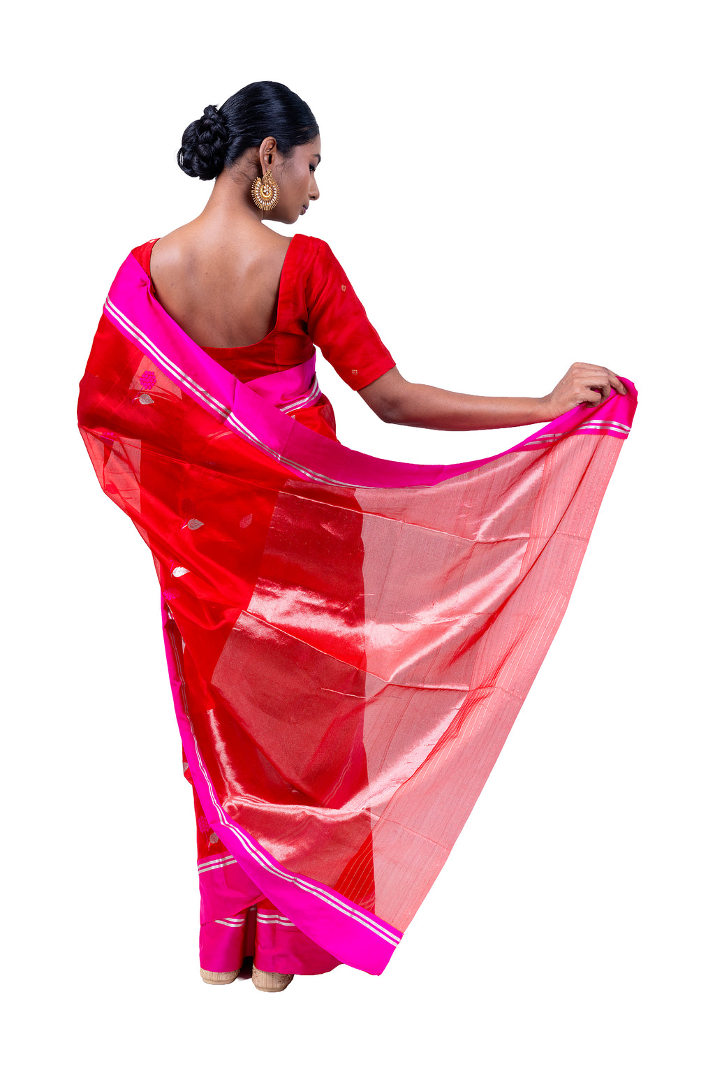 Woman wearing a red and pink saree with a white background