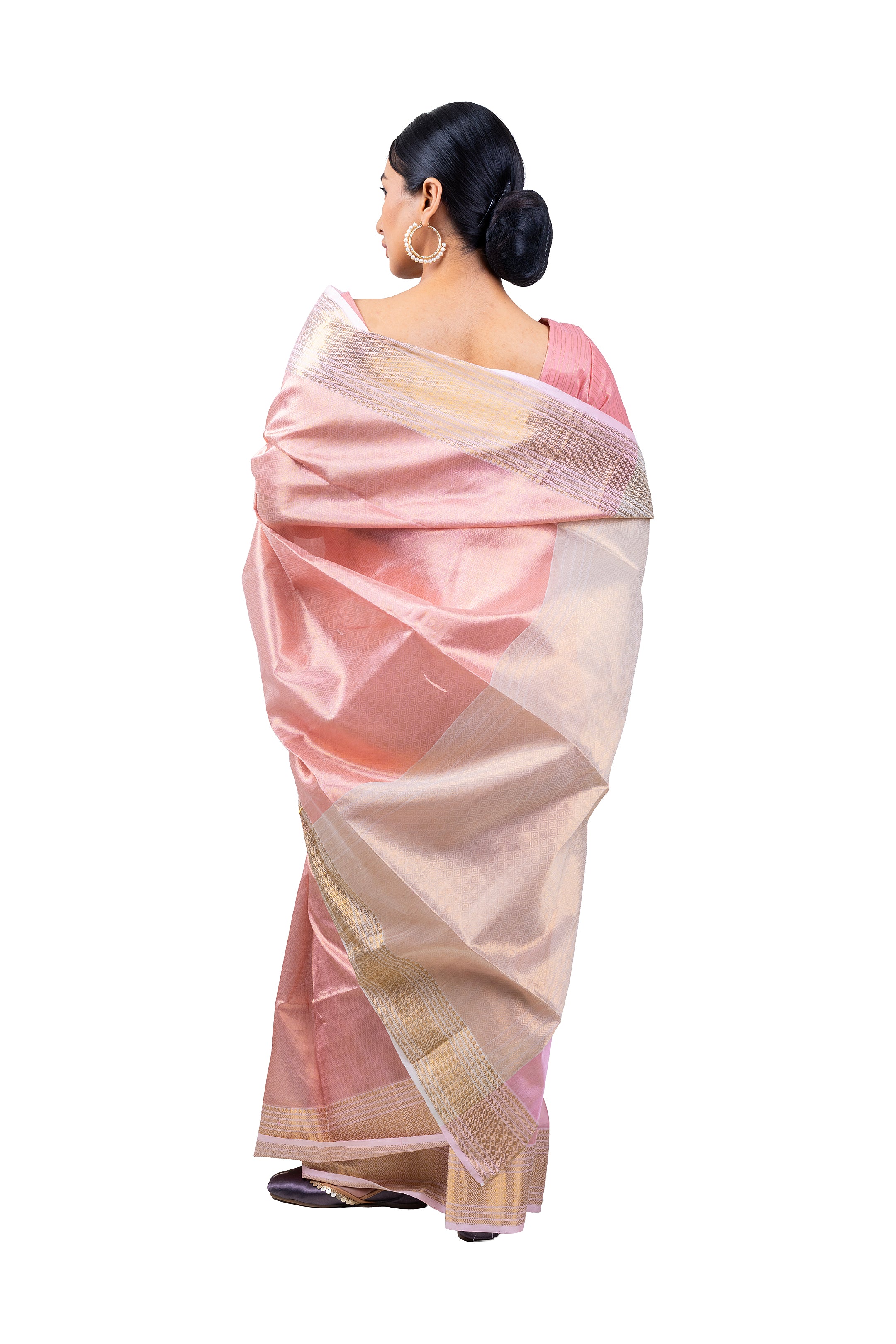 Woman wearing a pink and white saree on a white background
