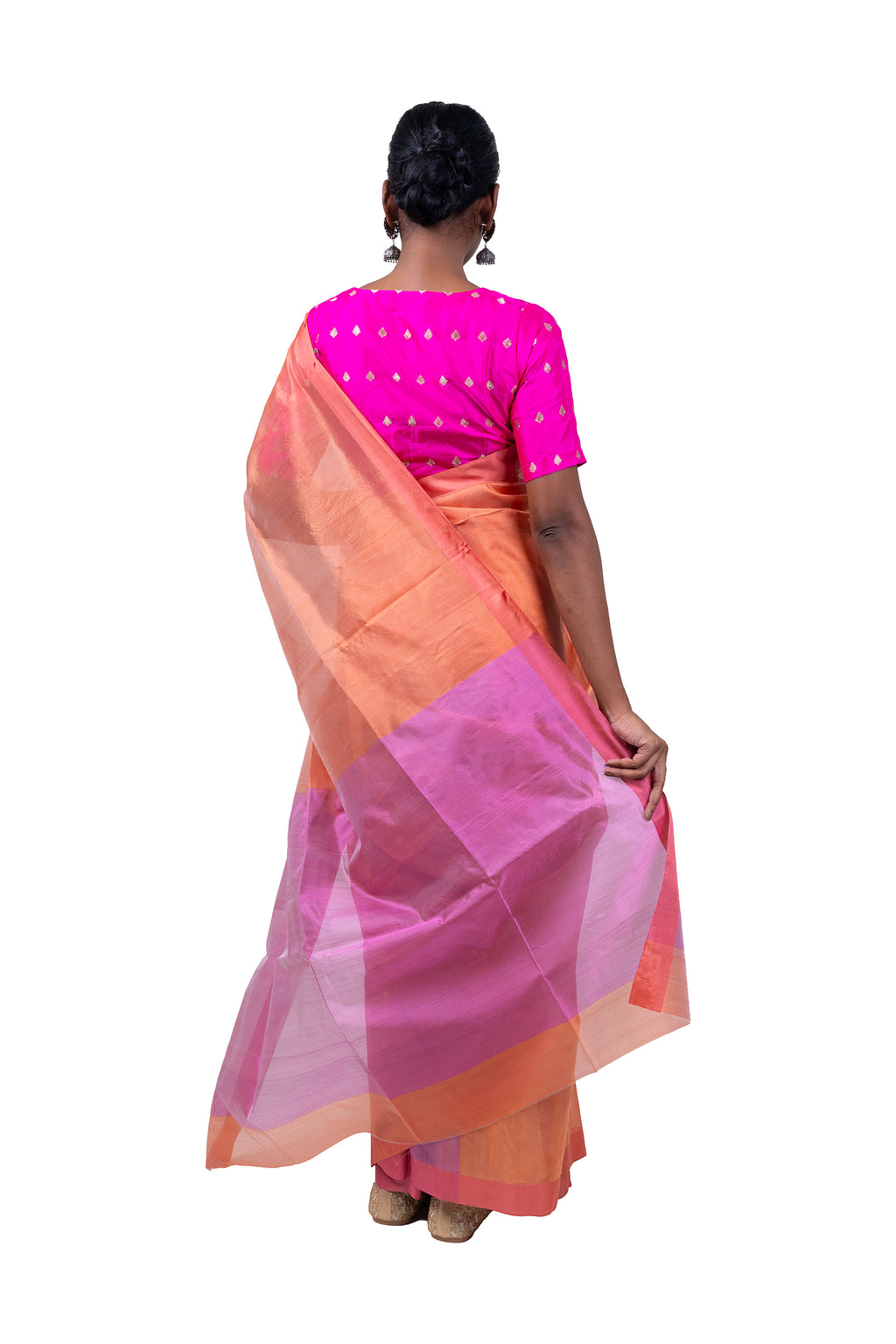 Woman wearing a pink and orange saree with a white background