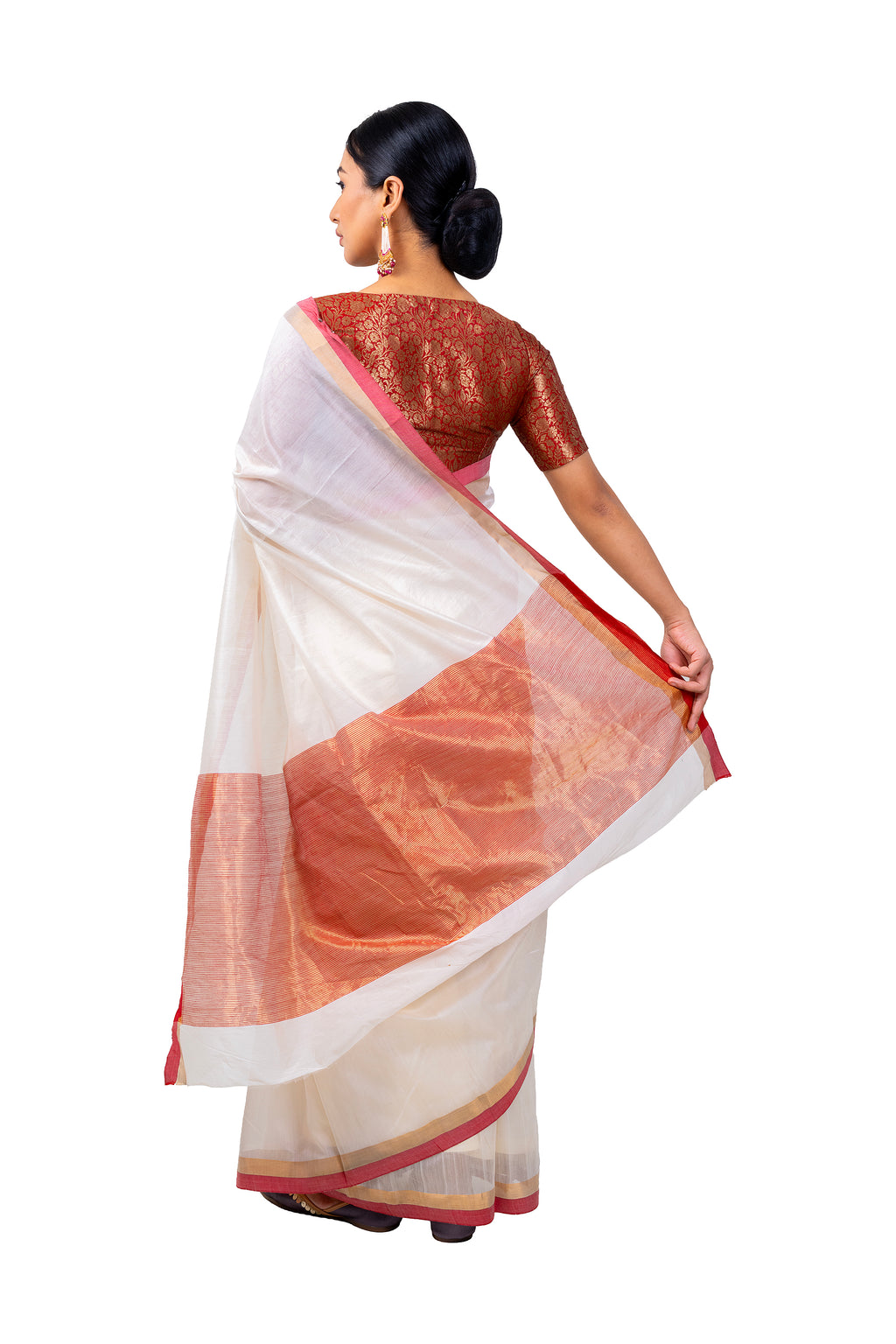 Woman wearing a traditional saree with a white and brown design on a white background