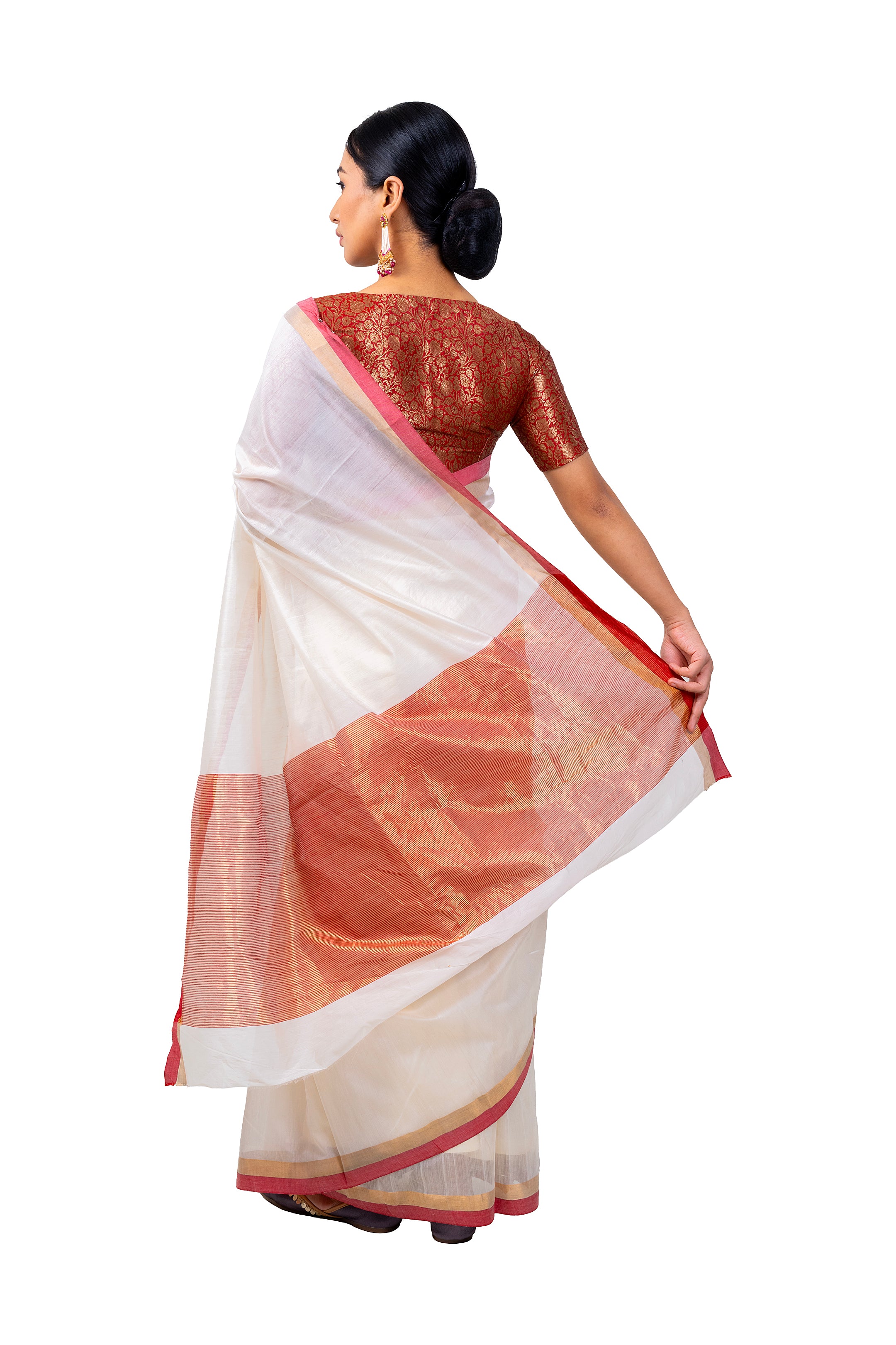 Woman wearing a traditional saree with a white and brown design on a white background