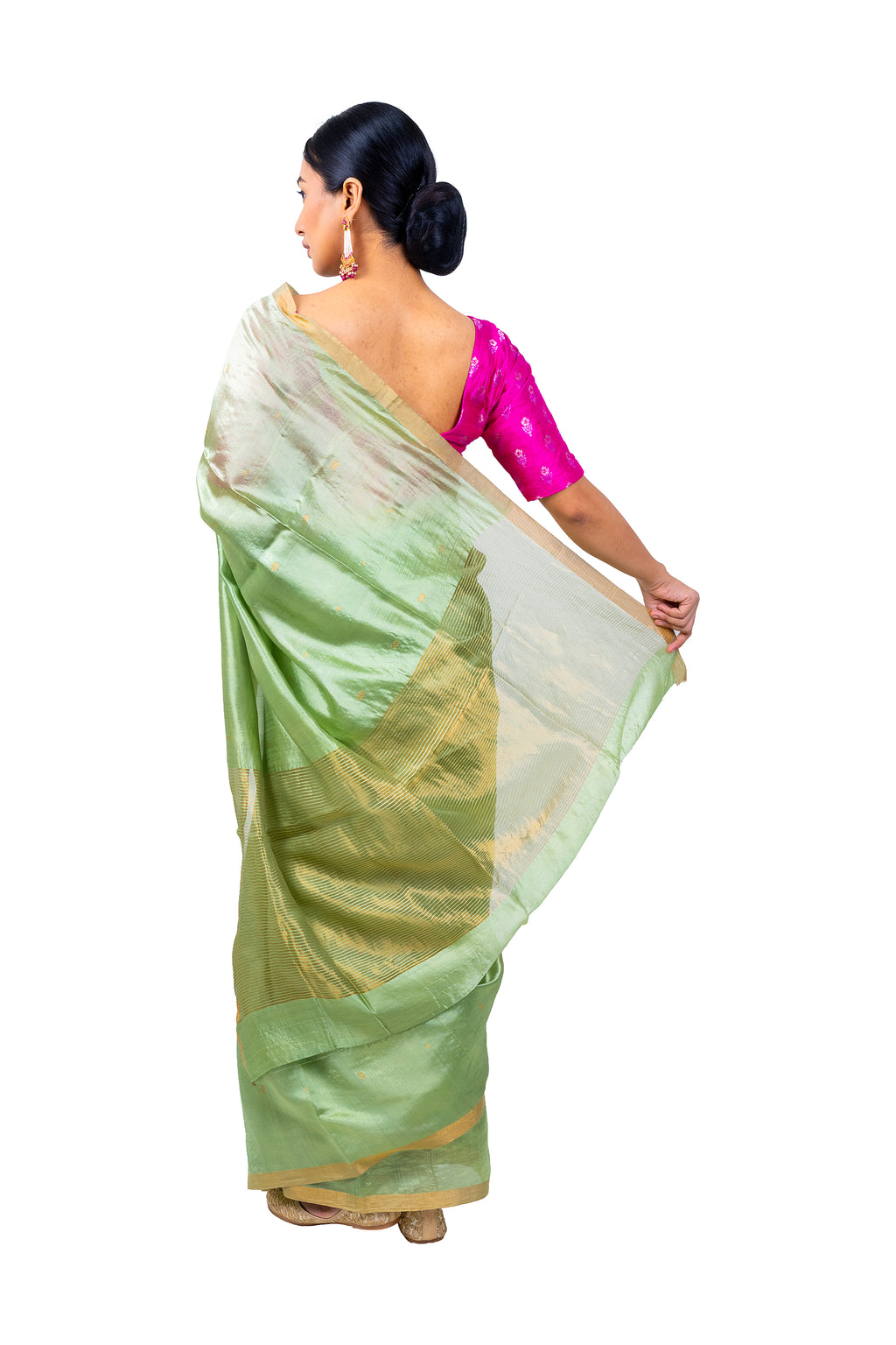 Woman wearing a green saree with a pink blouse on a white background