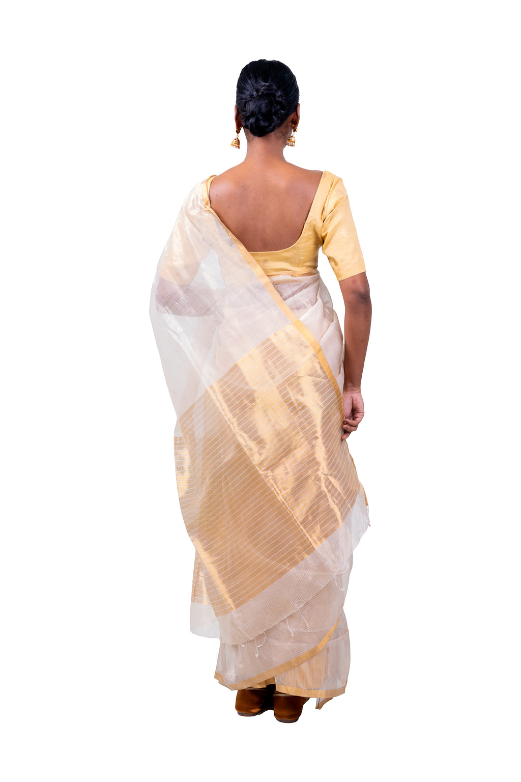 Woman wearing a white and beige saree on a white background