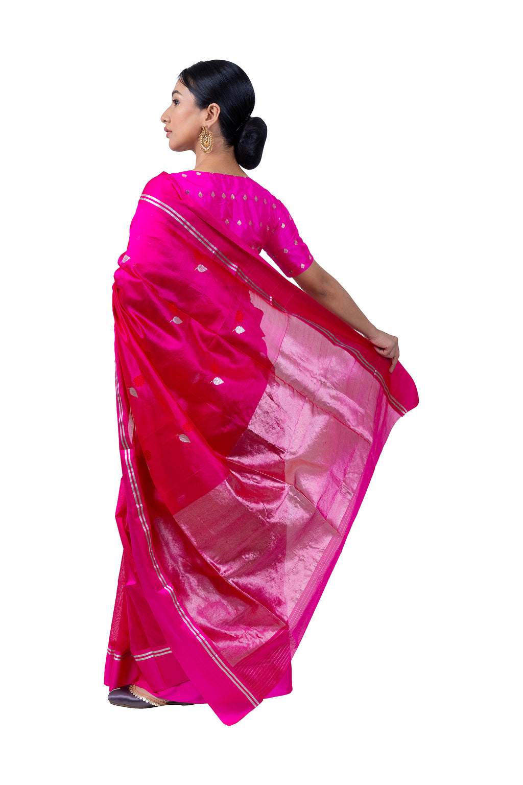 Woman wearing a bright pink saree with a white border on a white background